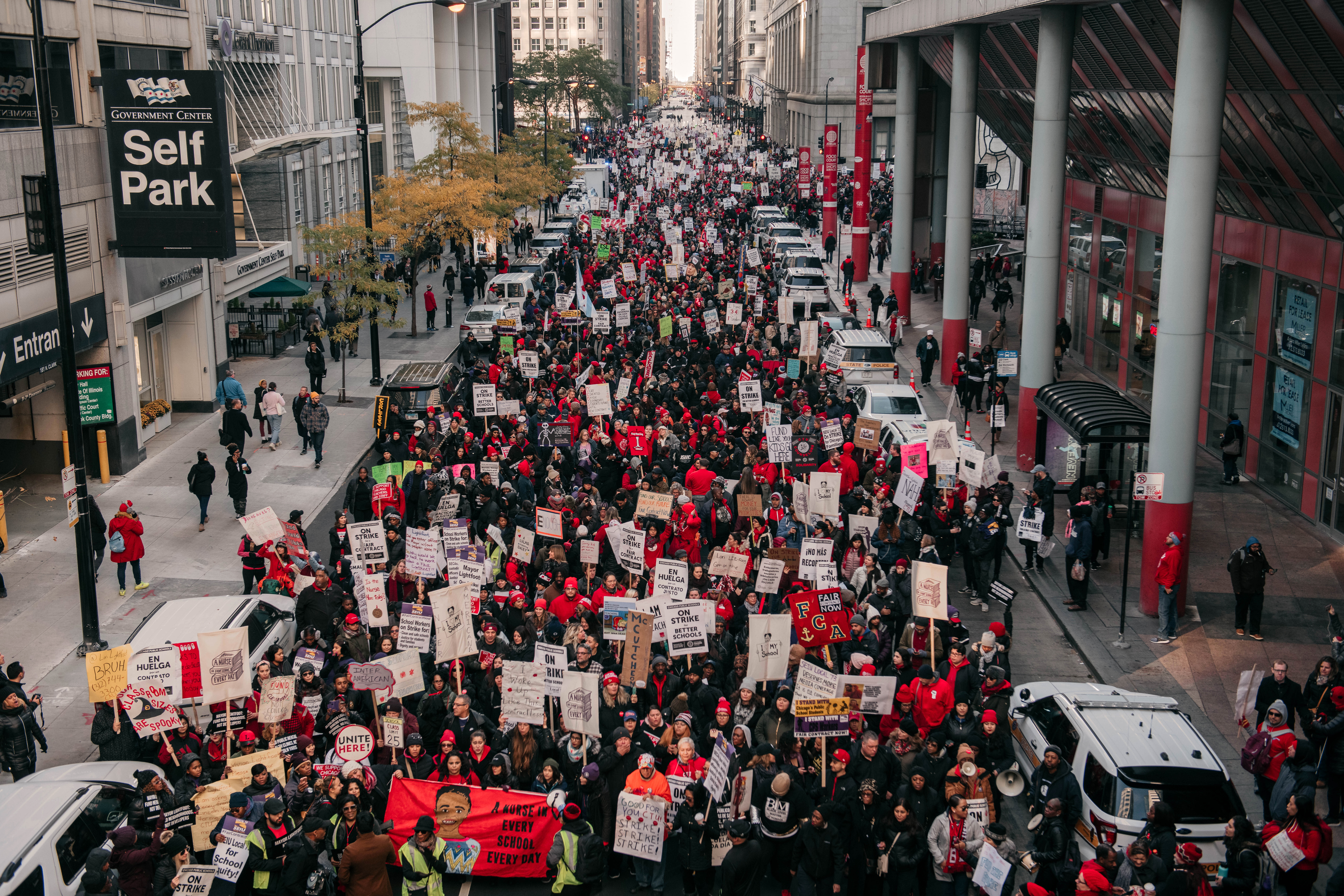 Chicago teachers march through a downtown street blocking car traffic.
