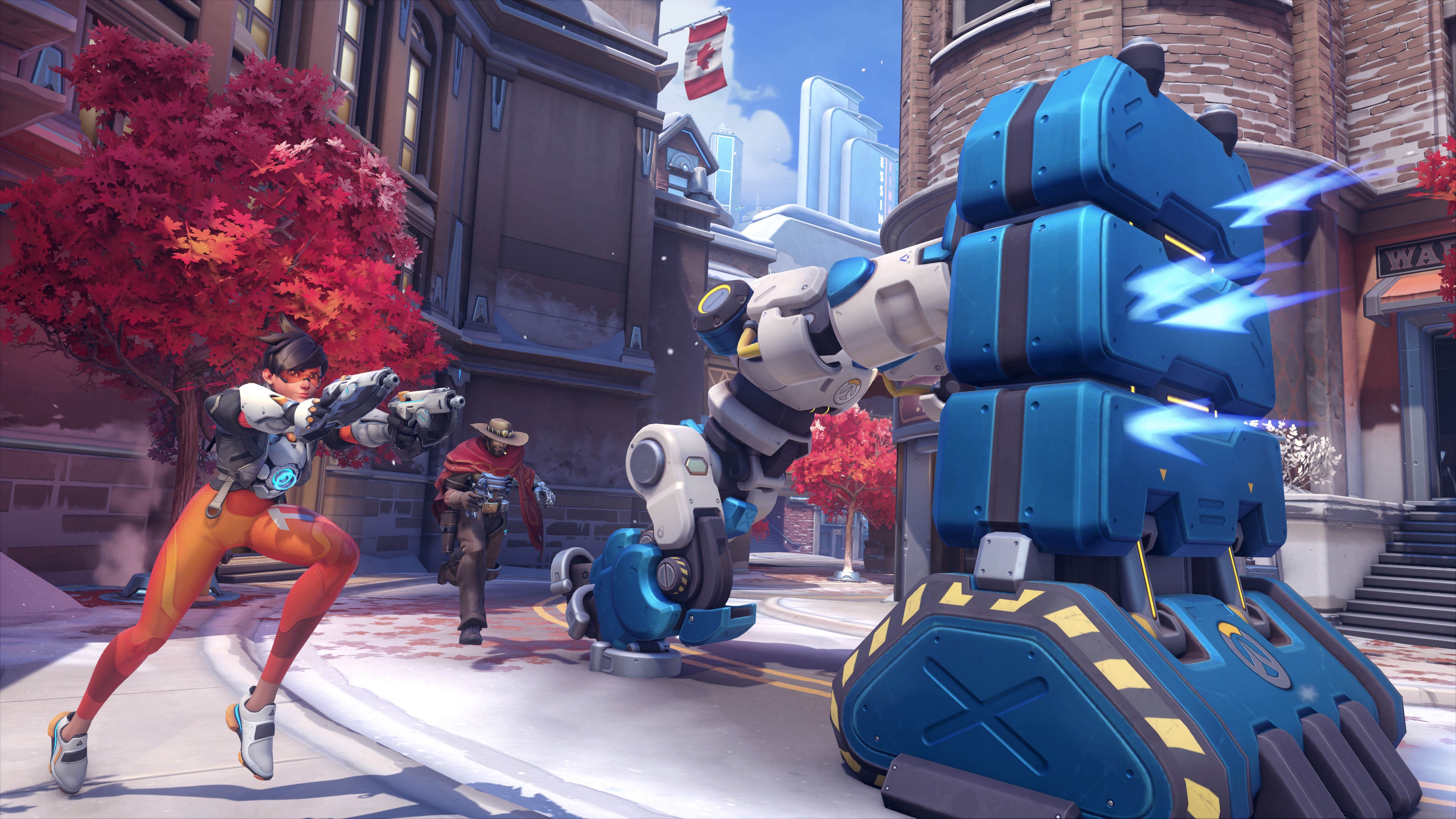 Tracer and Cassidy escort a robot pushing a large metal barrier in a screenshot from Overwatch 2’s Push mode, set on the Toronto map.