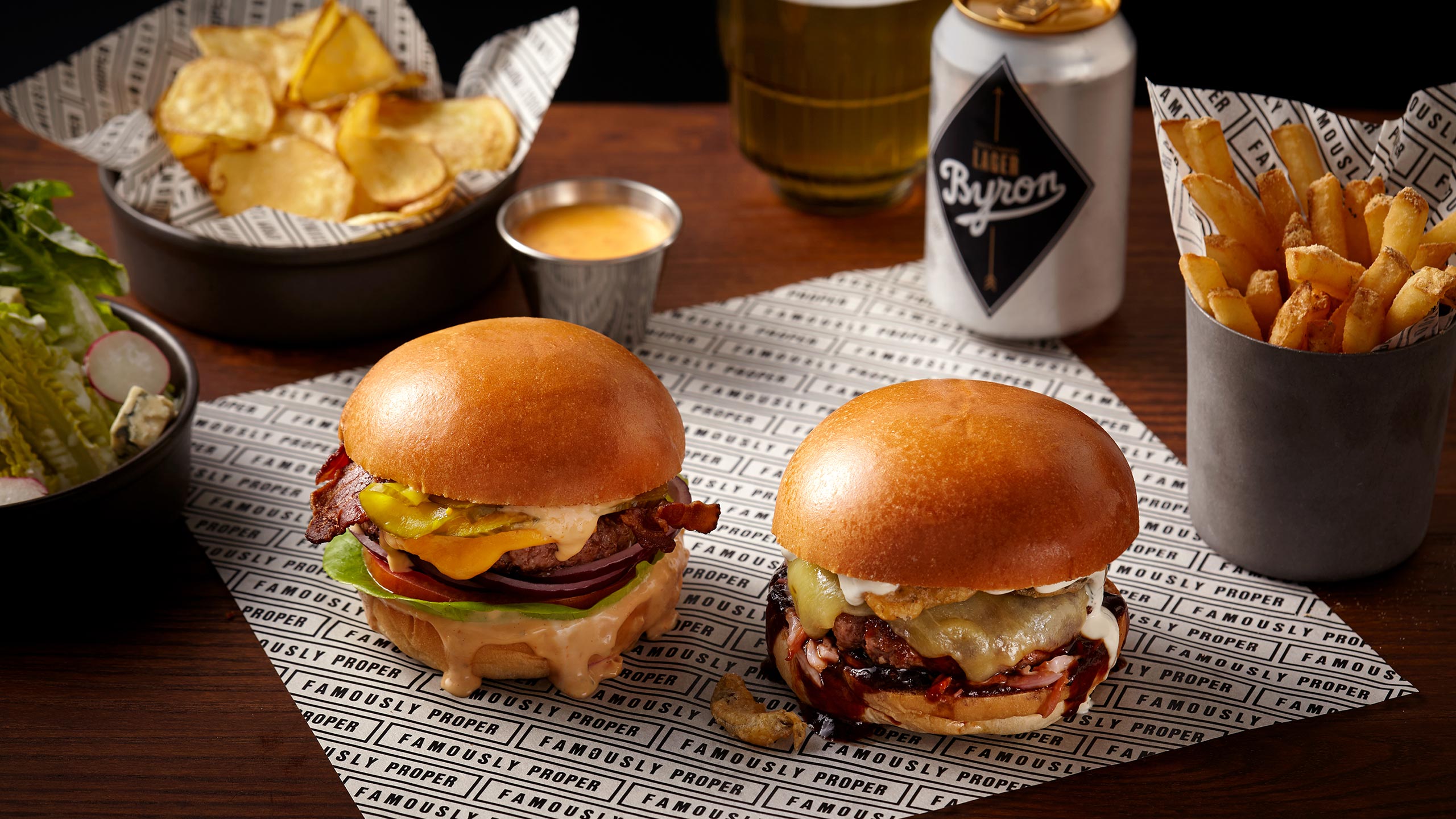 Byron Burger’s new burger menu, including the “new Byron” burger, fries, crisps, and Byron beer