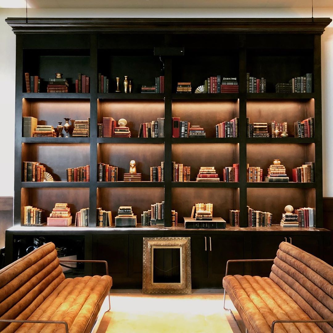 A library wall of books and shelves at an upcoming Los Angeles supper club.