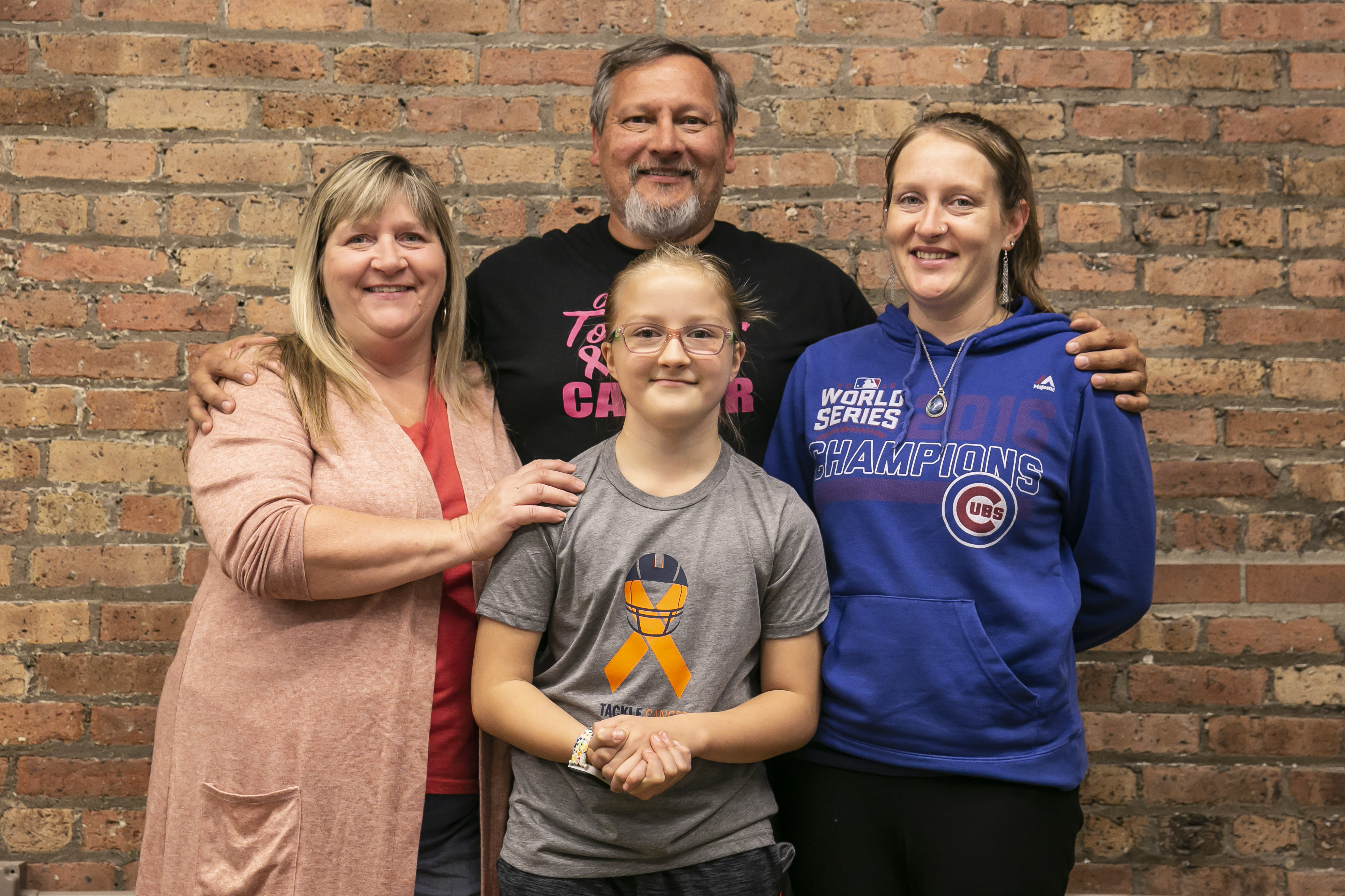 Caedyn Waxman,9, with, from left, Grandmother Tina Chesser, Grandfather Gene Chesser and Mom Courtney Chesser. | Rich Hein/Sun-Times