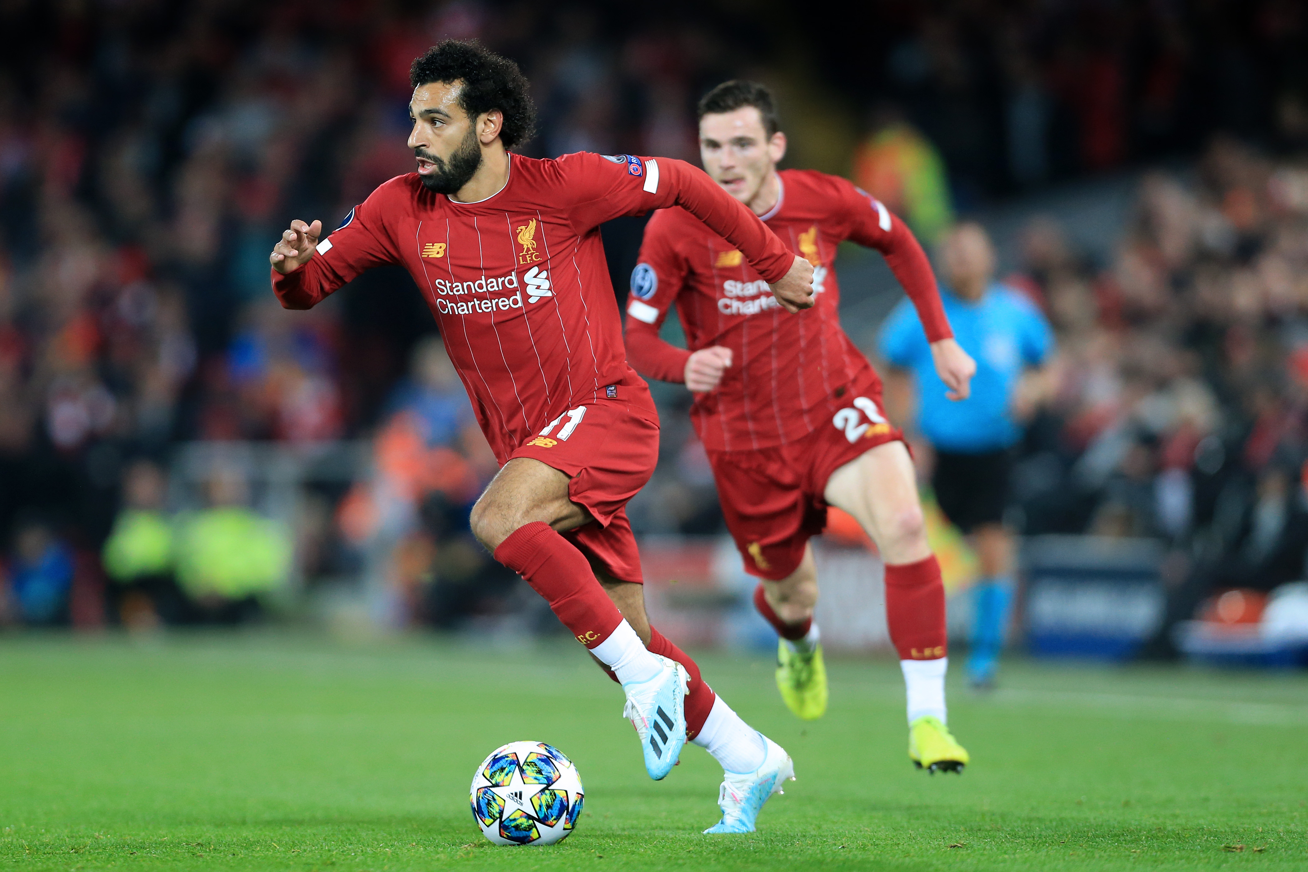 Mohamed Salah in action with the ball, trailed by Andrew Robertson - Liverpool FC - Premier League