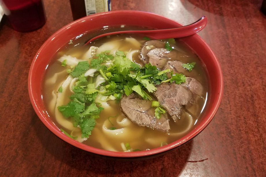 Hand-pulled noodles in broth topped with beef and cilantro 