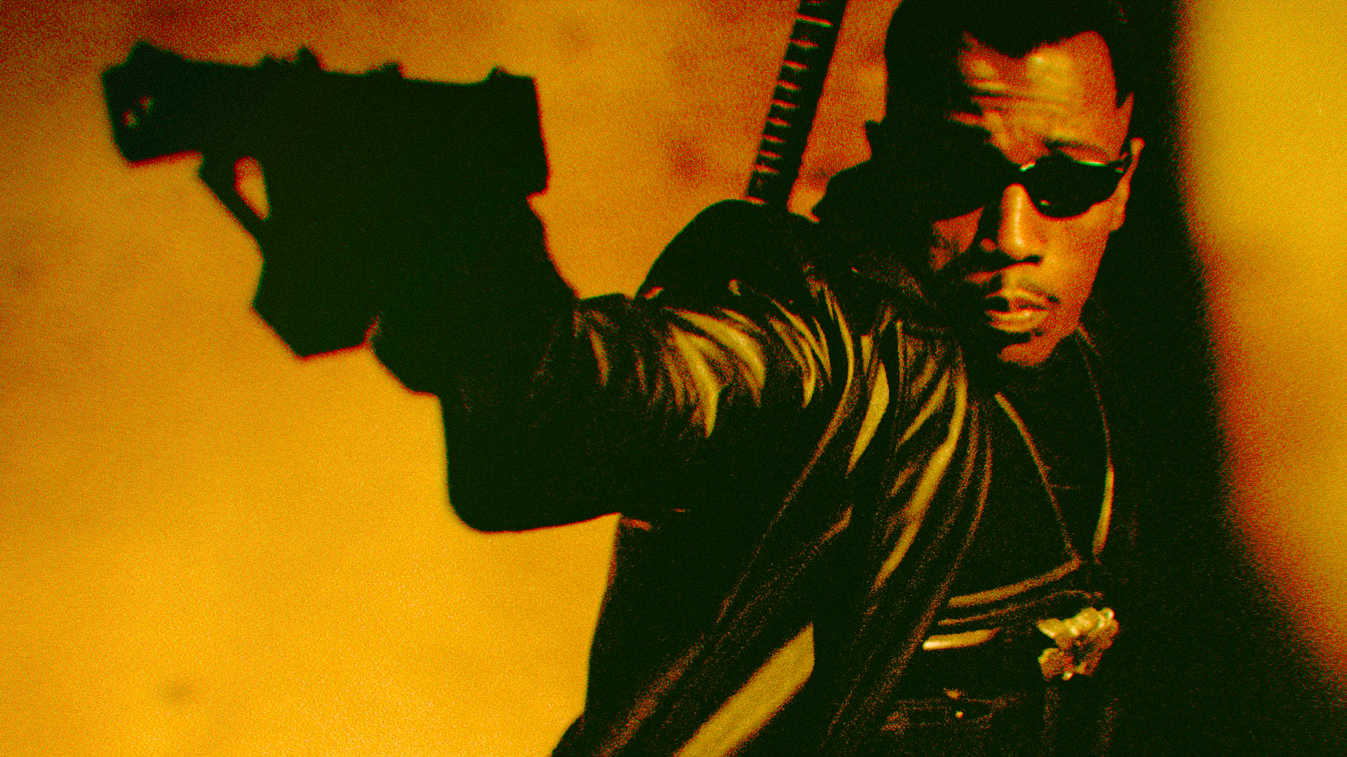 Actor Wesley Snipes raises a gun in a scene from the film Blade