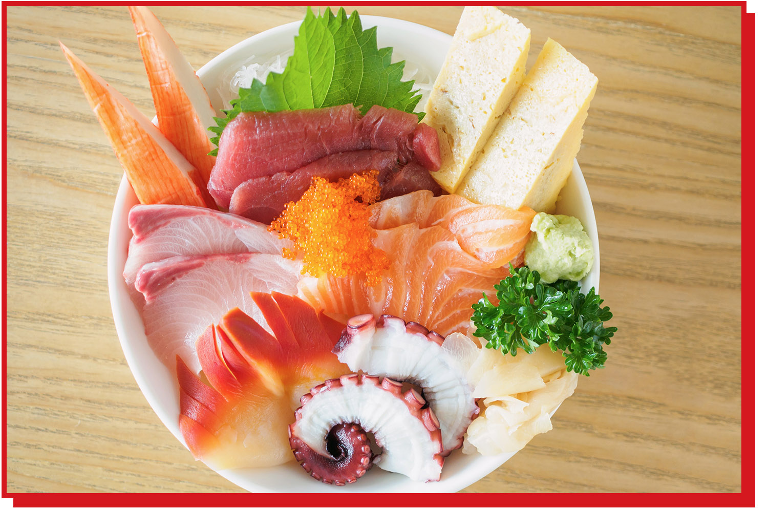 Chirashi bowl featuring salmon, tuna, octopus, tamago, whitefish.