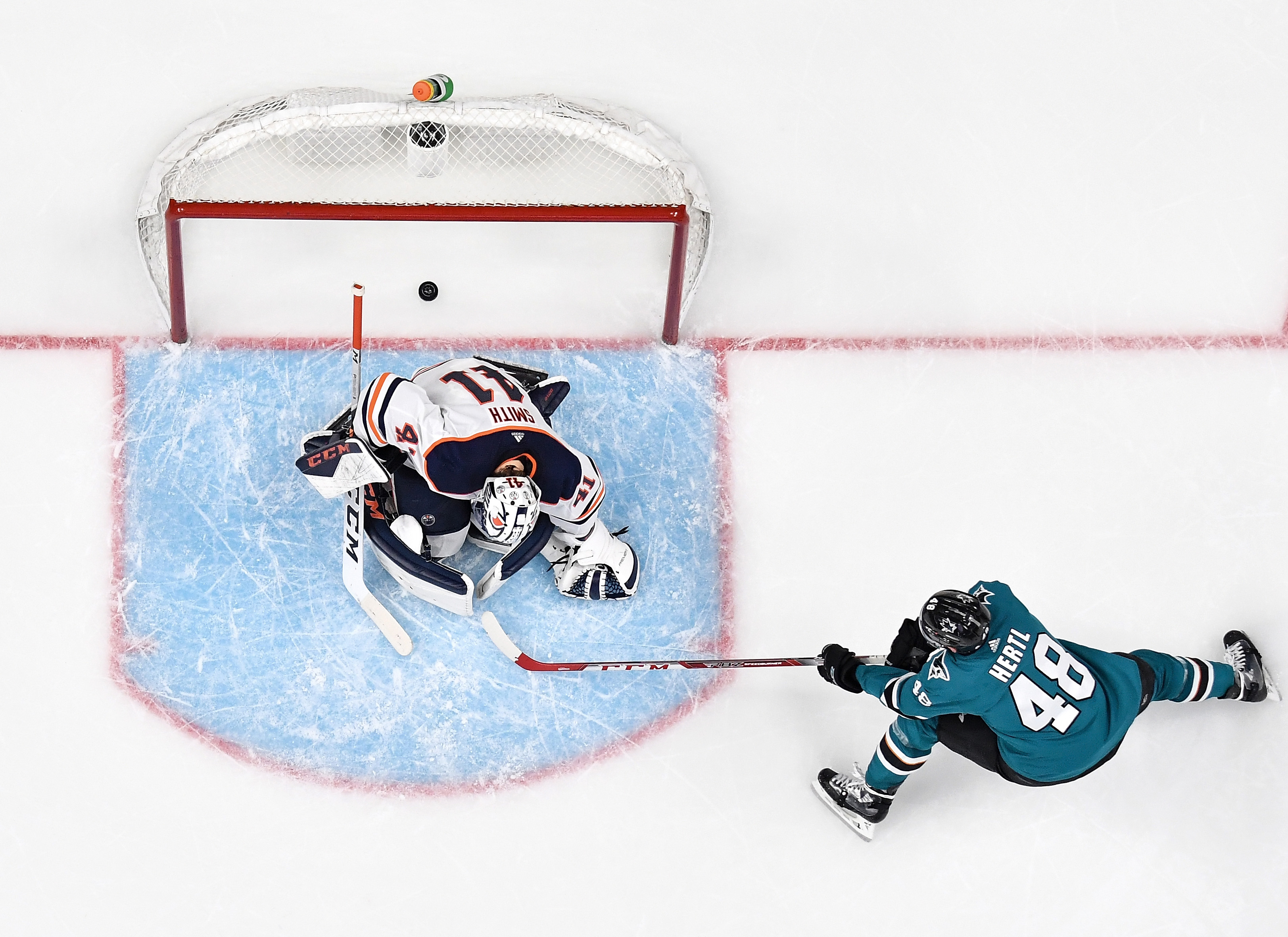 An overhead view as Tomas Hertl #48 of the San Jose Sharks scores a goal against Mike Smith #41 of the Edmonton Oilers at SAP Center on November 12, 2019 in San Jose, California.
