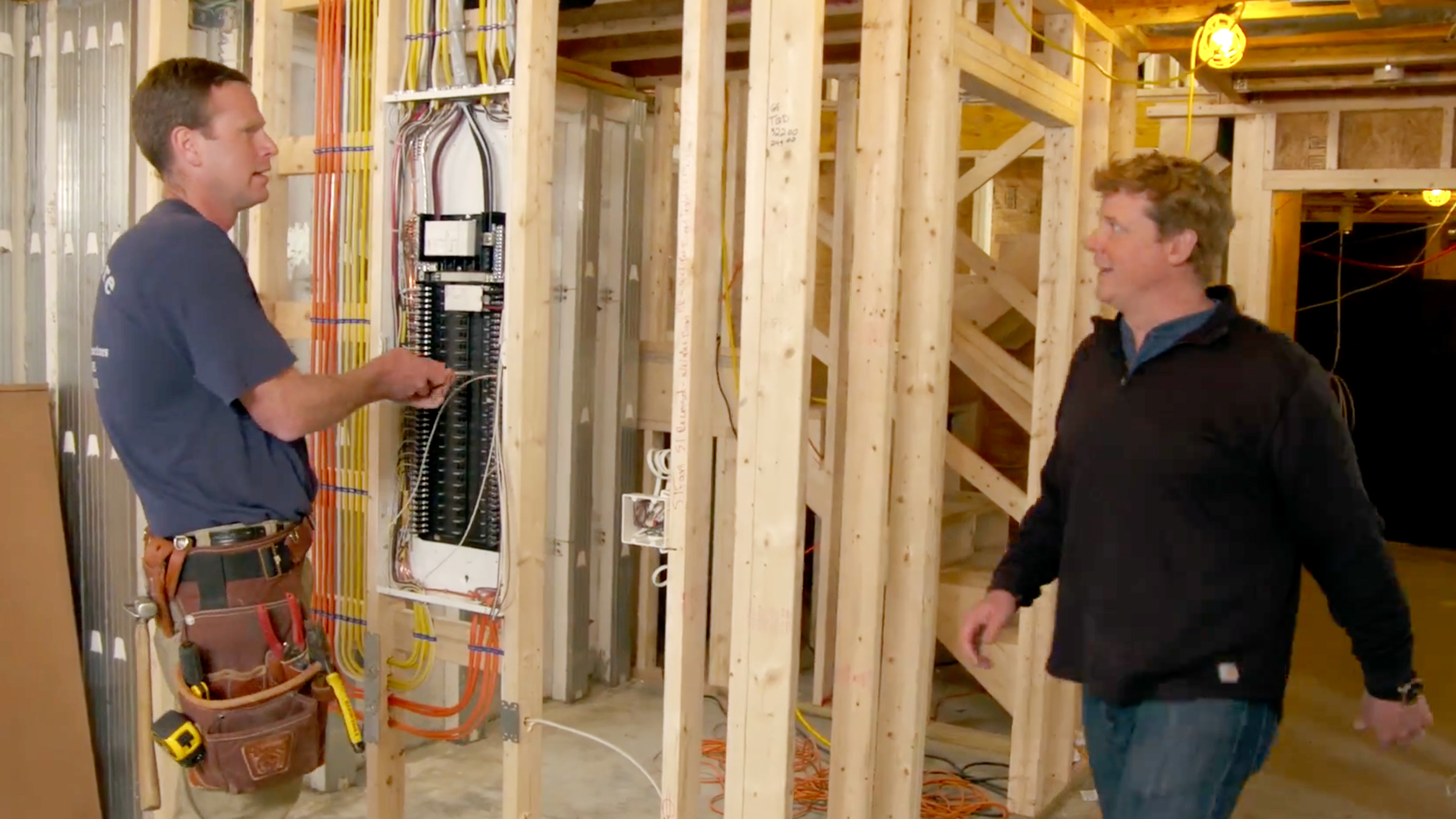 Ben Giles shows Kevin O’Connor a smart electrical panel at the Narragansett Idea House
