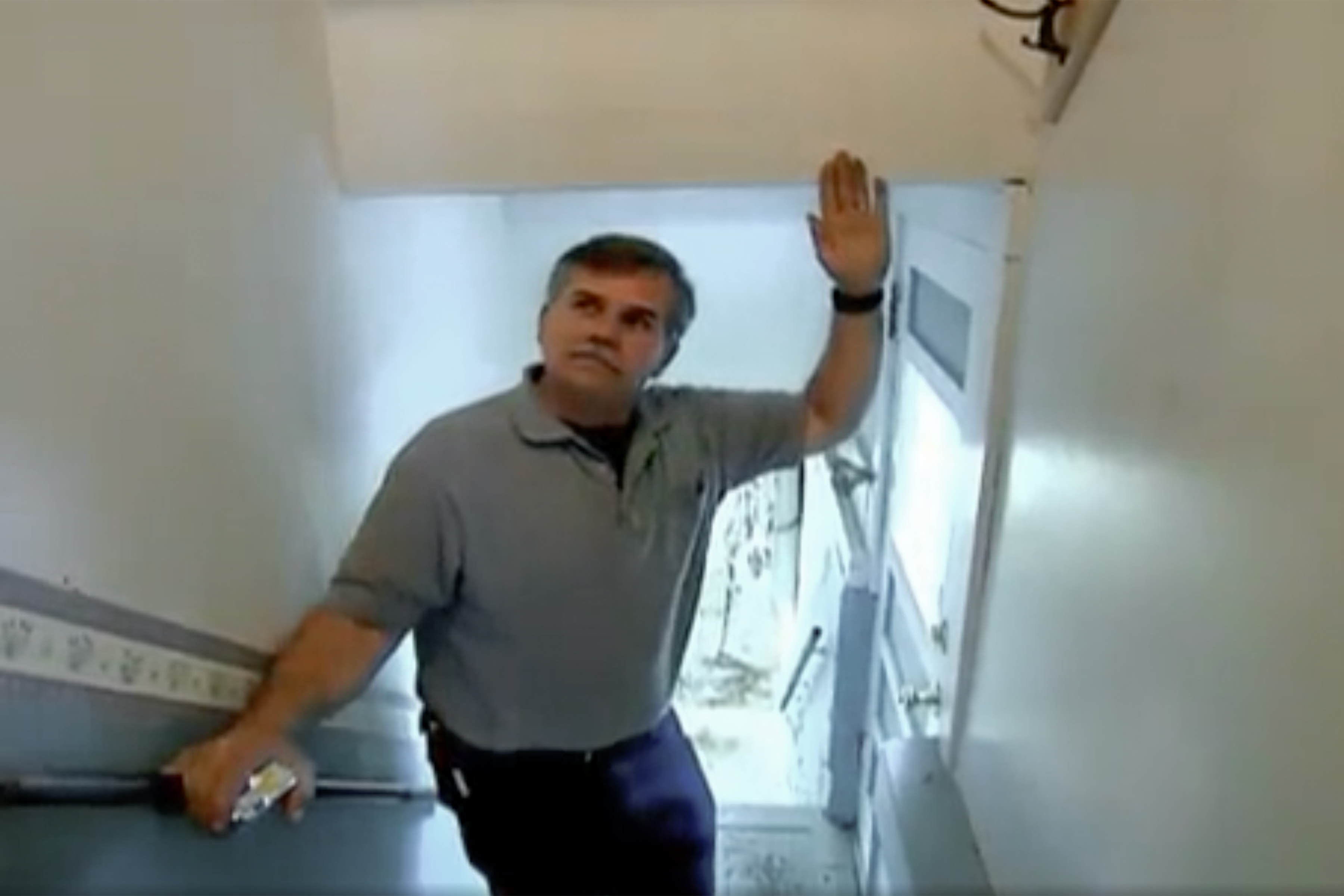 Tom Silva standing in a stairway with a low ceiling.