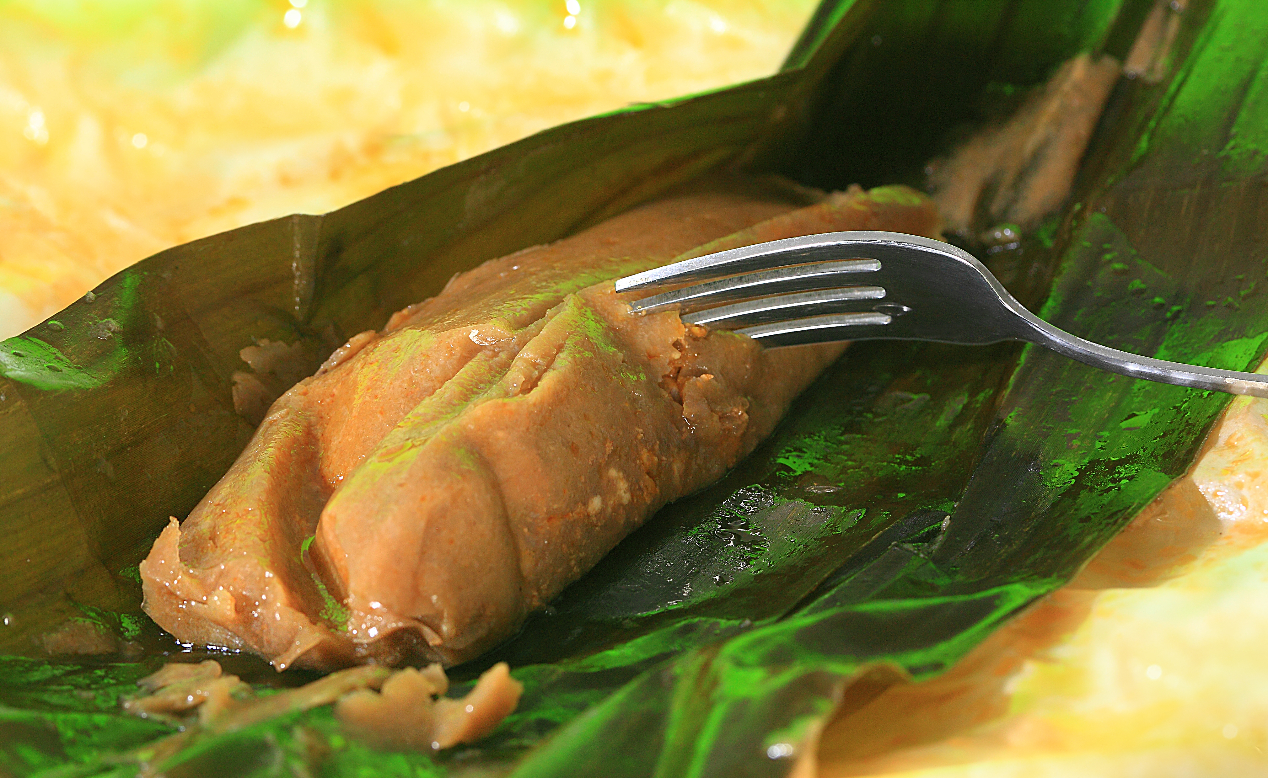 A fork digs into an open pasteles 