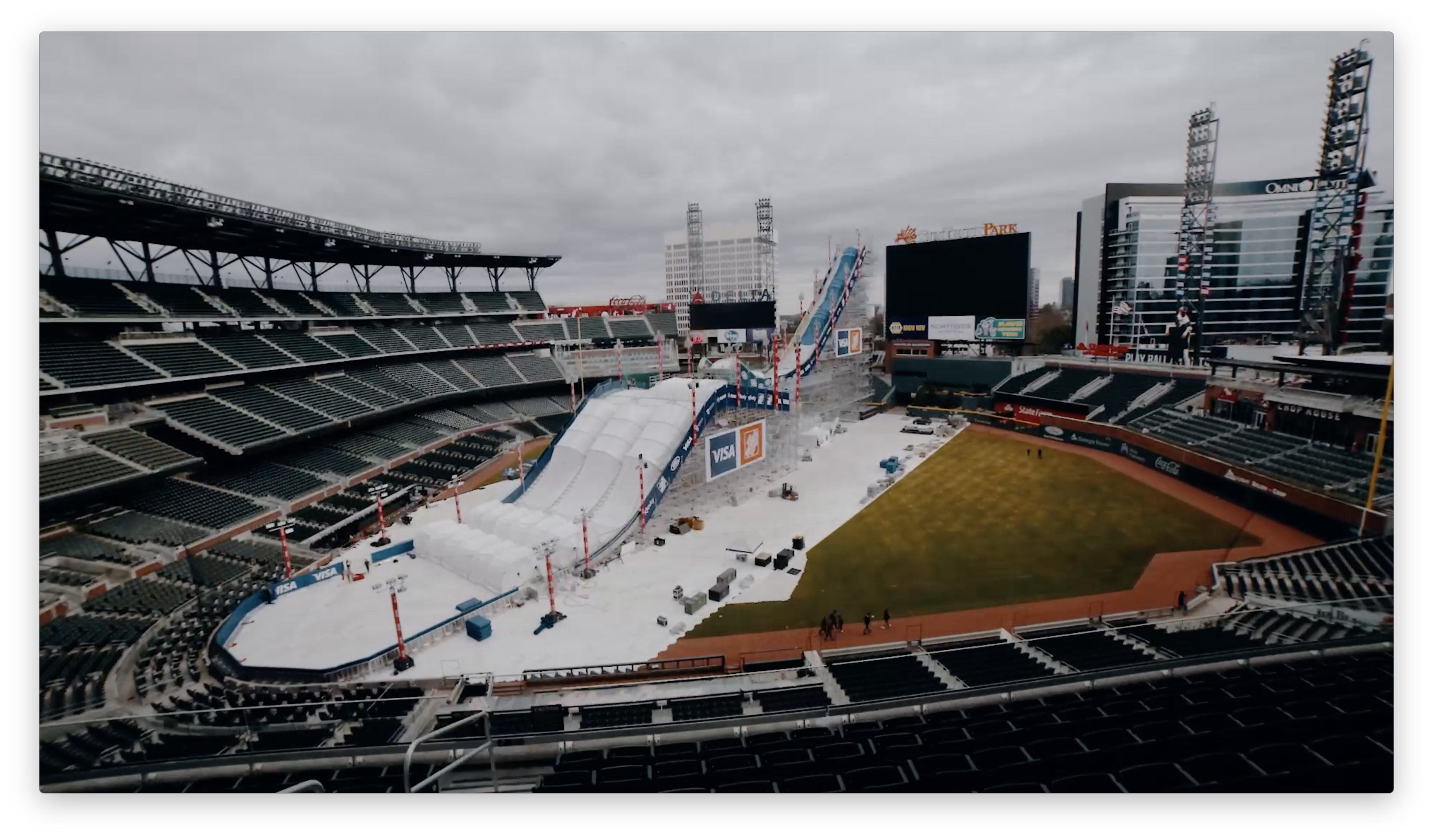 A massive white ramp being built in the middle of a baseball stadium.