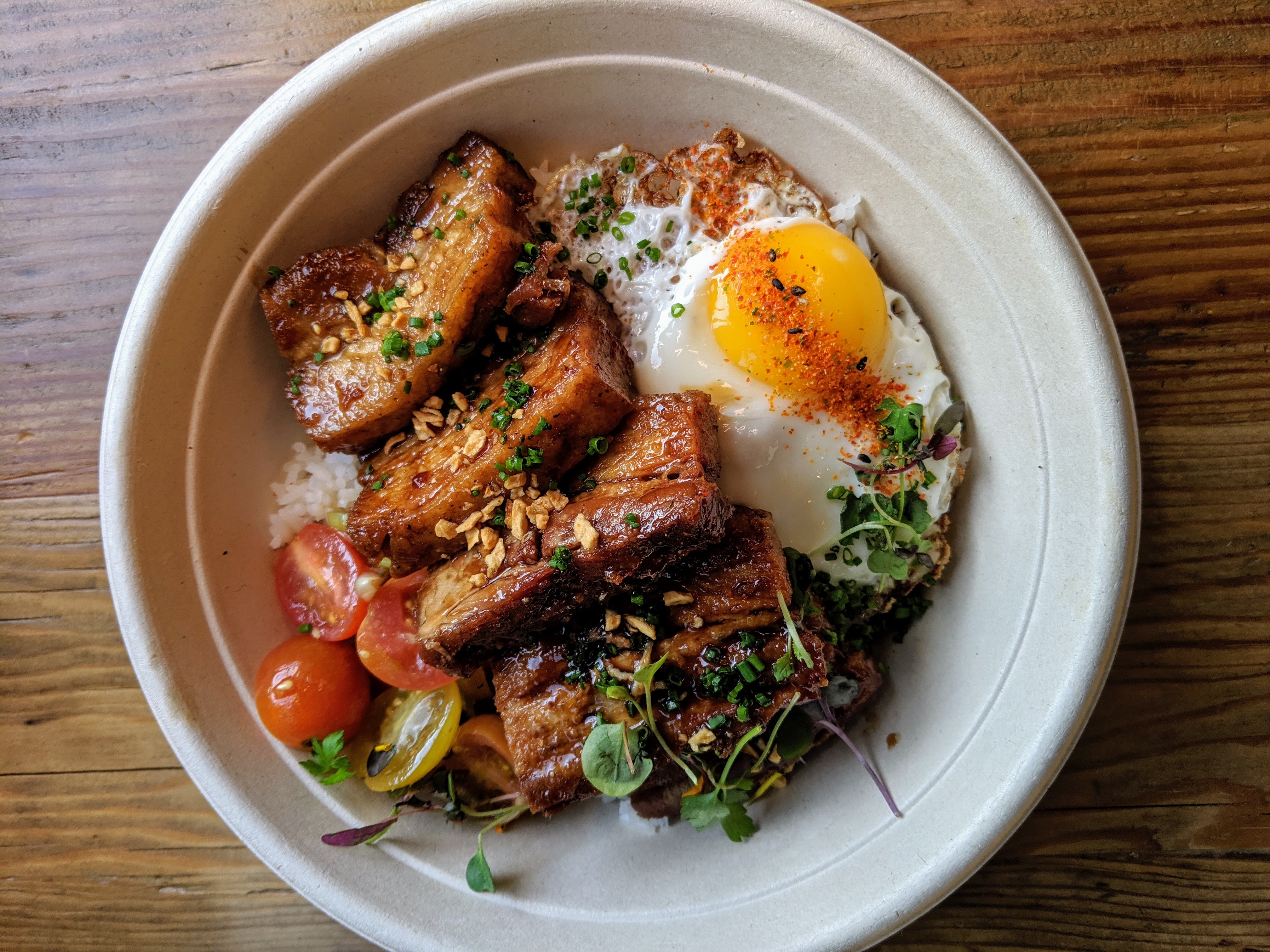 A bowl with rice, pork, fried egg, and vegetables at Spoon &amp; Pork in Los Angeles