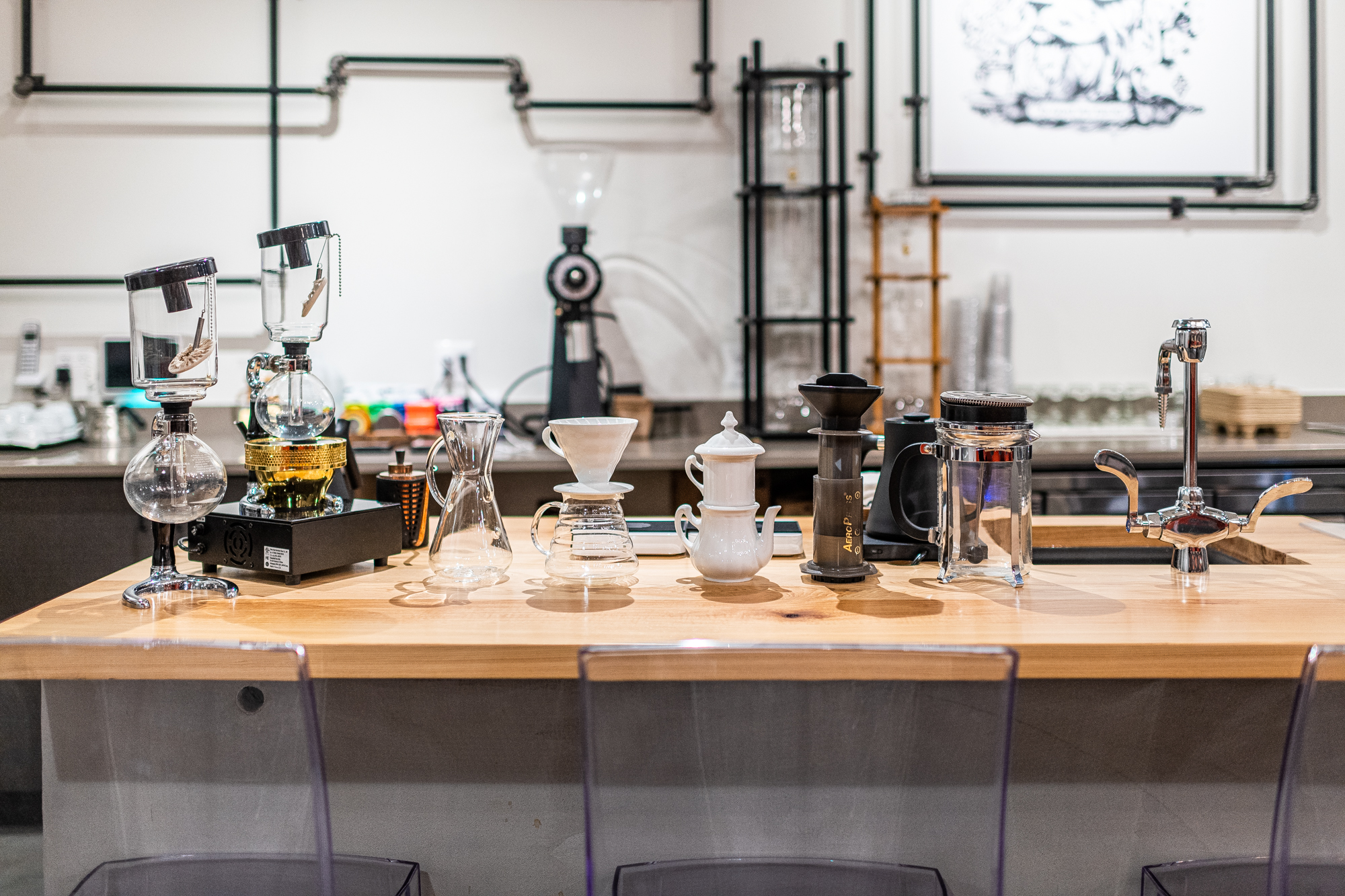 A host of different brewing devices sit on a wooden countertop inside Sweet Science.