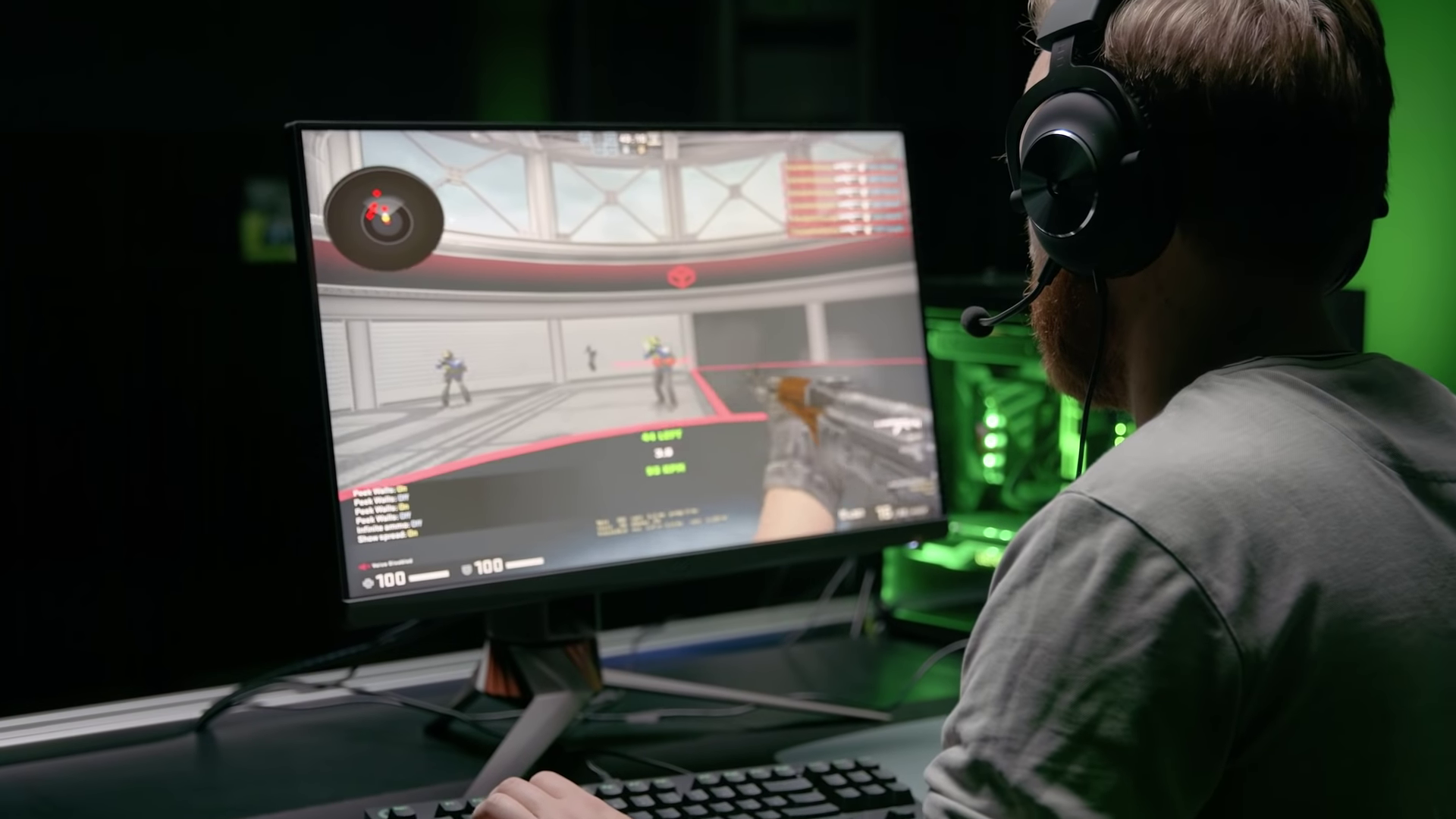 a man wearing a gaming headset playing a game on a computer monitor