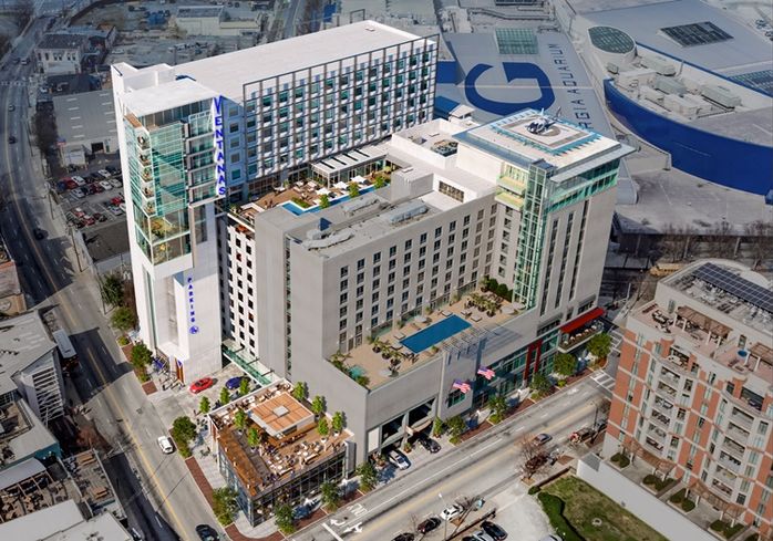 A rendering of the a very modern hotel that shoots up from the roof of the parking deck.