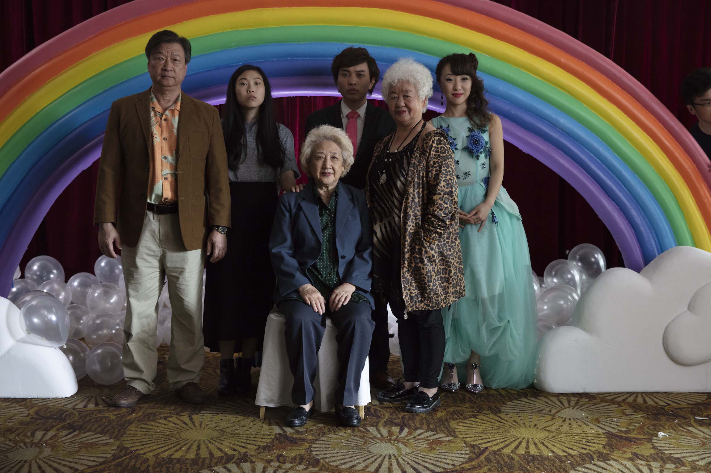 a Chinese family stands in front of a rainbow structure in The Farewell