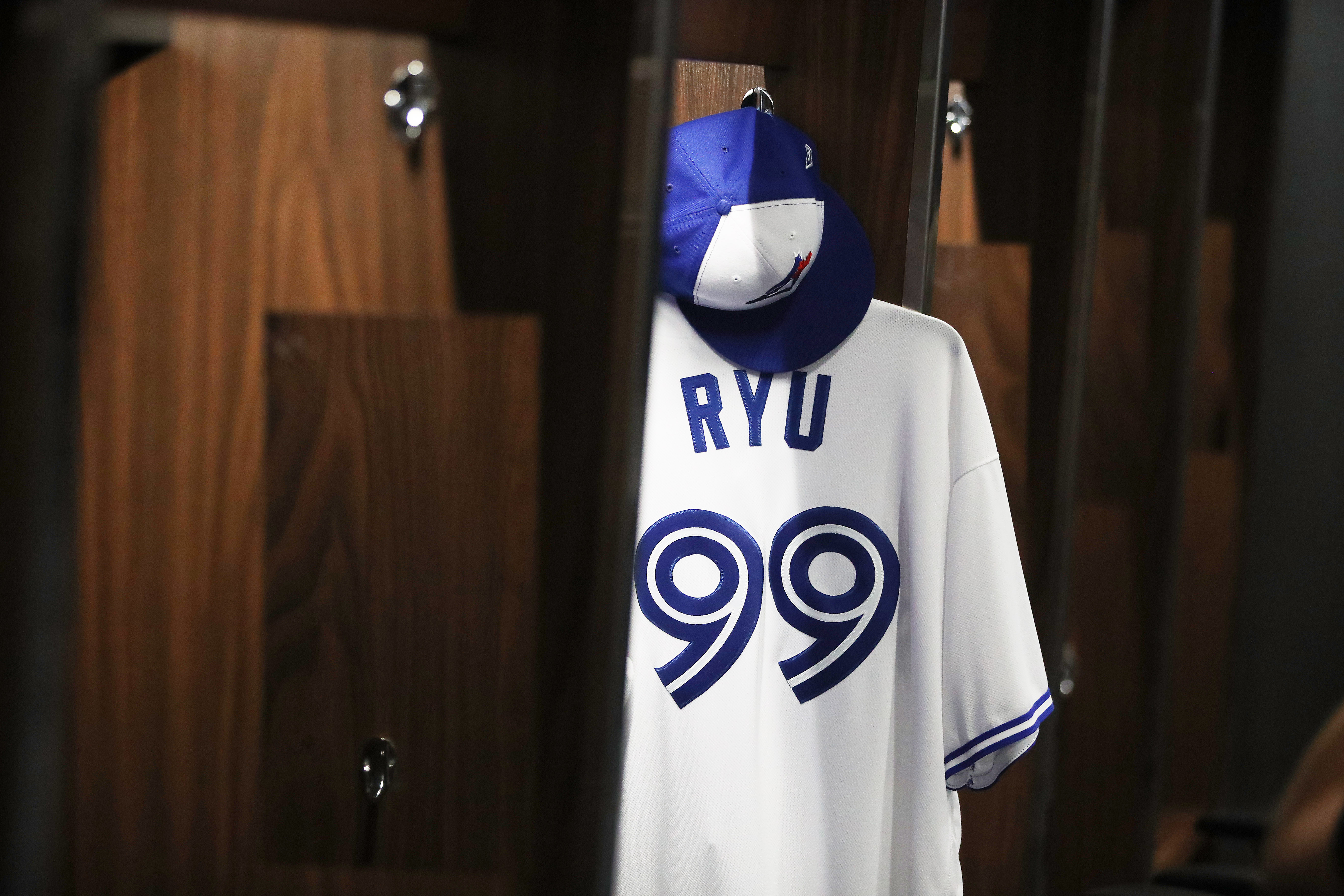 Hyun-Jin Ryu’s #99 white Blue Jays jersey hanging in the clubhouse.