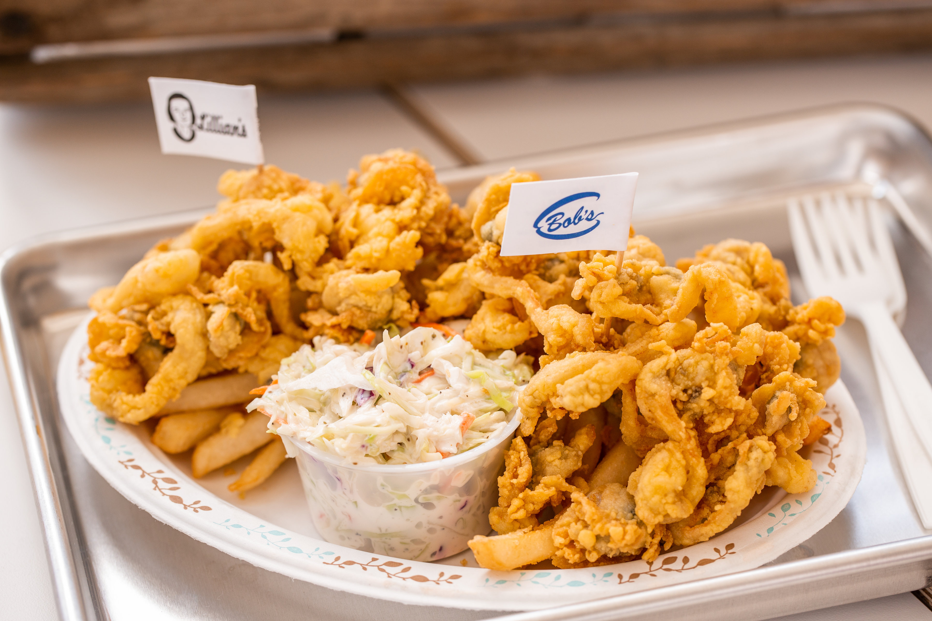 Fried seafood platter with clams, fries, and coleslaw