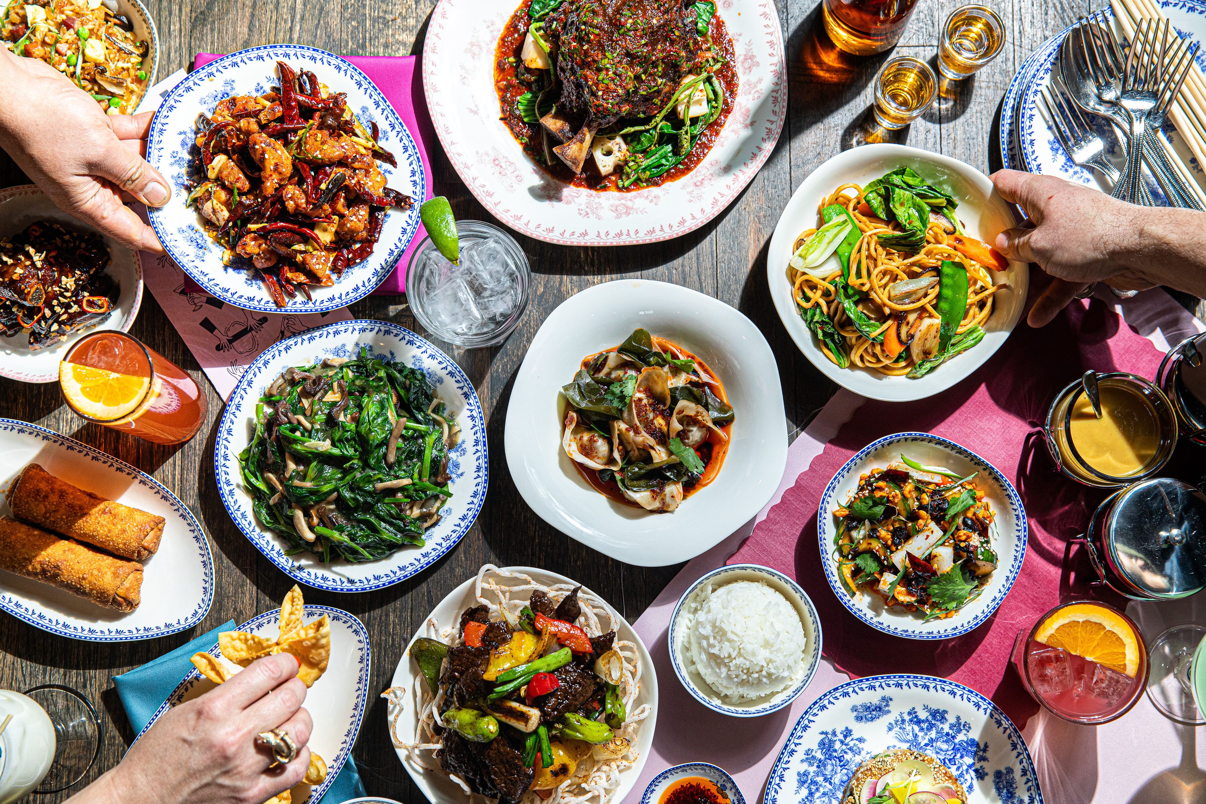 Several plates of Chinese-American food on a table.