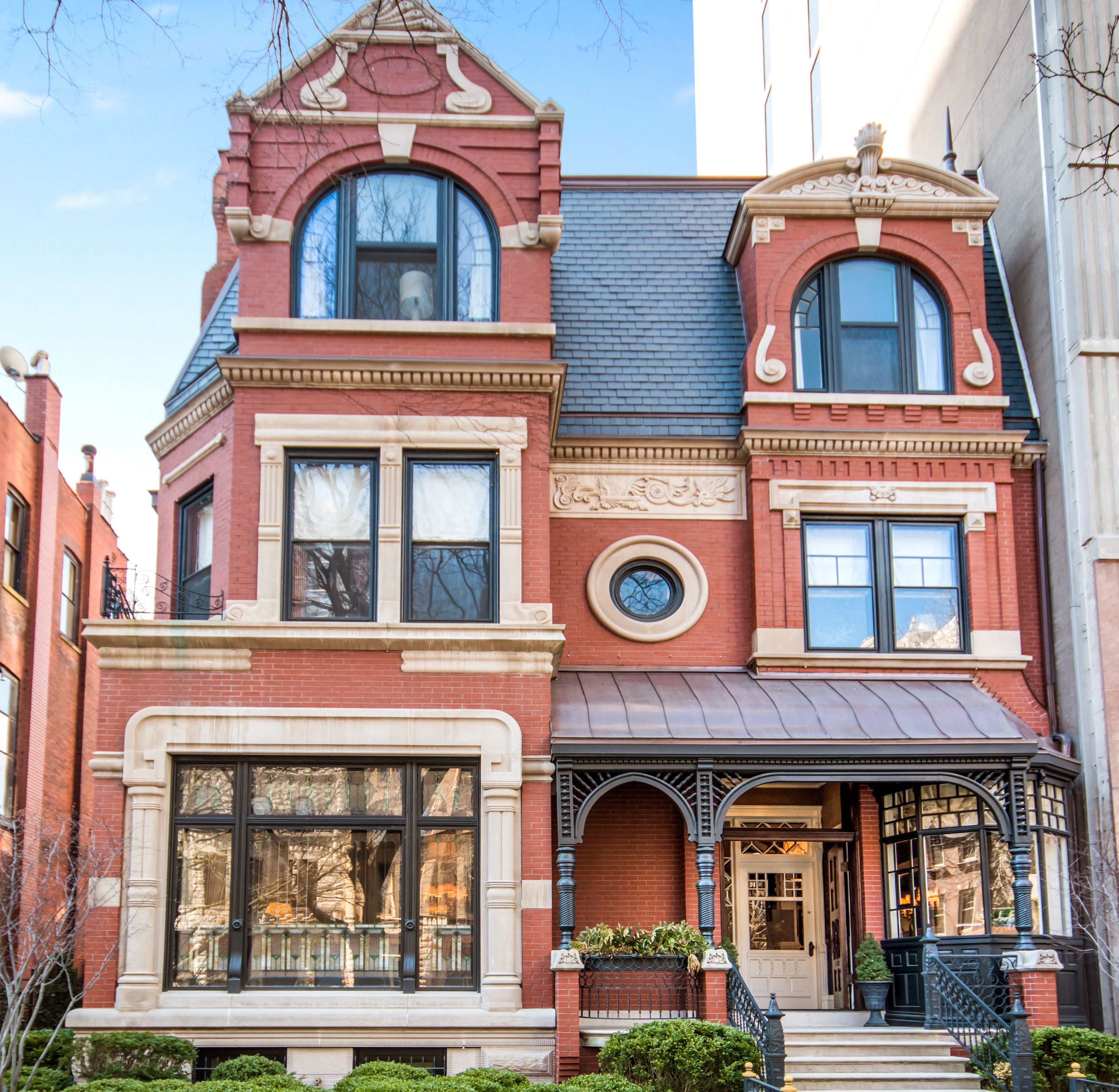 An three-story single-family home with historic trim, windows, moldings, and turrets. 