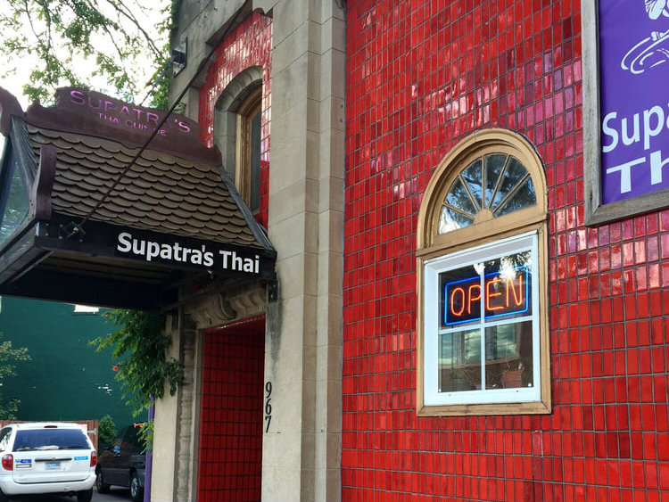 The shiny red tile exterior and purple sign outside Supatra’s