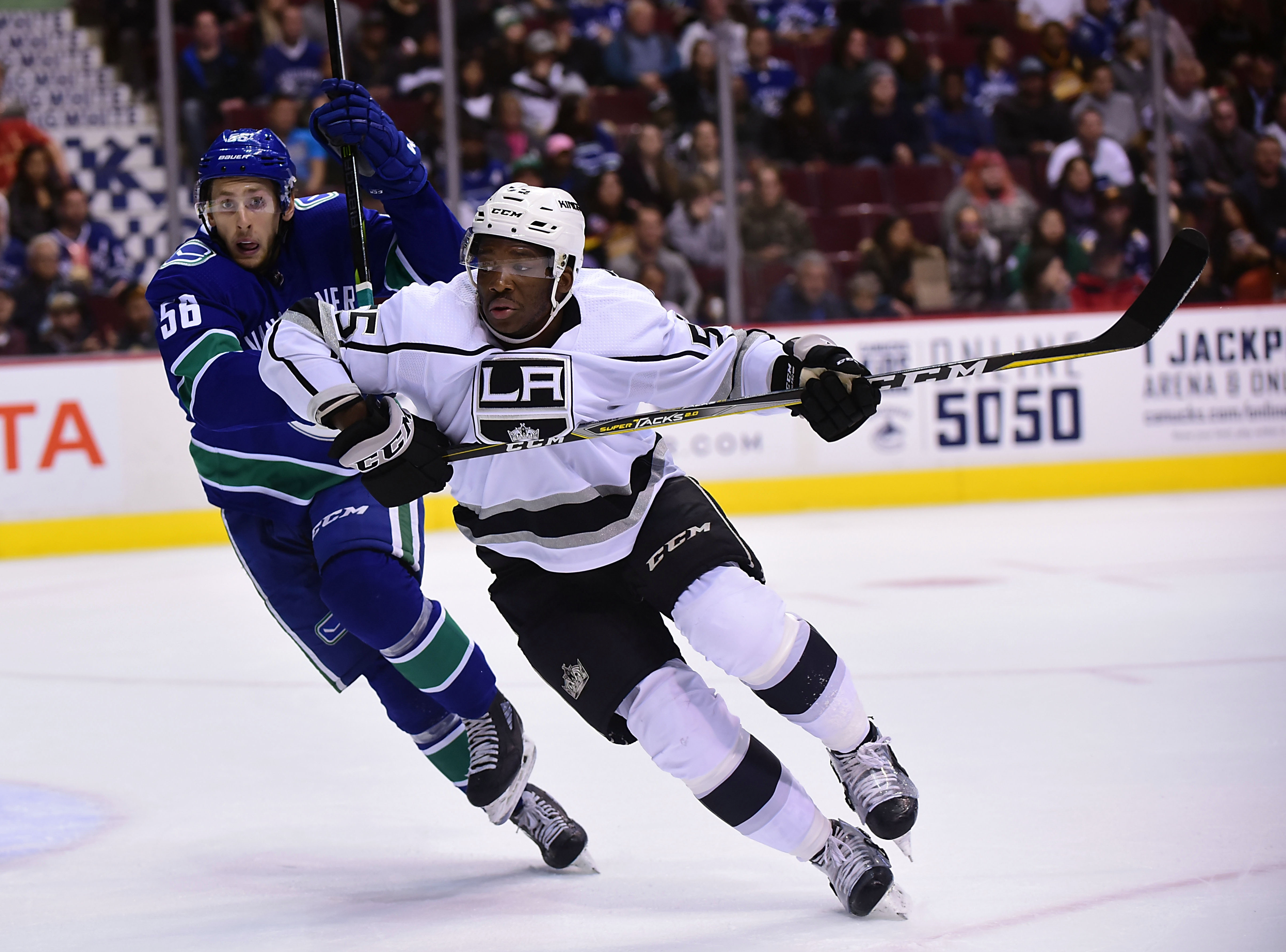 Sep 20, 2018; Vancouver, British Columbia, CAN; Los Angeles Kings forward Boko Imama (55) skates against Vancouver Canucks defenseman Guillaume Brisebois (56) during the second period at Rogers Arena.