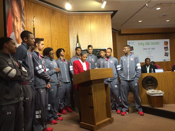 Denver Public Schools Board President Happy Haynes, center, in March recognized the East High School boy's basketball team for winning the state's championship tournament. Under Haynes' leadership Denver's school board has displayed few disagreements in public.
