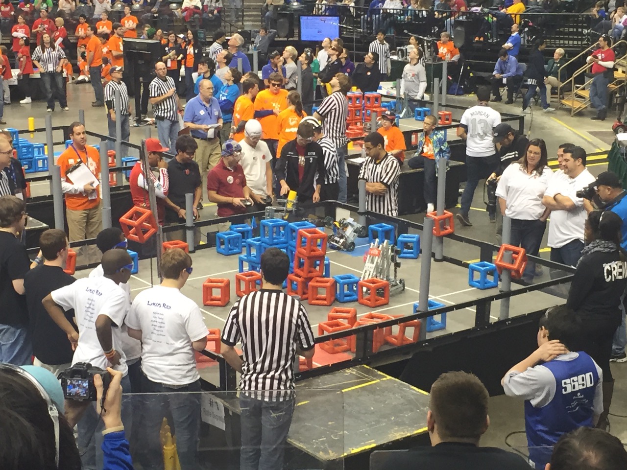 Providence Cristo Rey High School's robotics team competes in the VEX tournament Sunday. The goal of the challenge is to stack cubes on the gray goalposts or build towers in the arena.