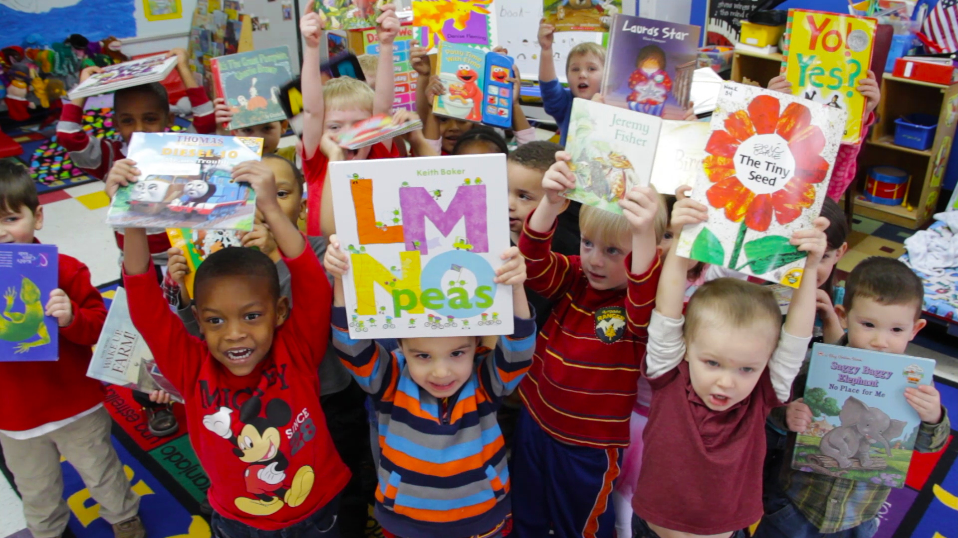 Children at a Porter-Leath classroom show off their new books. Porter-Leath is the largest provider of early childhood education in Memphis.