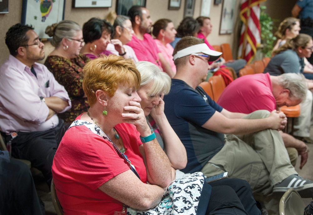 Members of the audience, mostly teachers and paraprofessionals, react to the 3-2 vote by the Pueblo school board to reject a recommendation for pay increases. (Chris McLean, The Pueblo Chieftain)