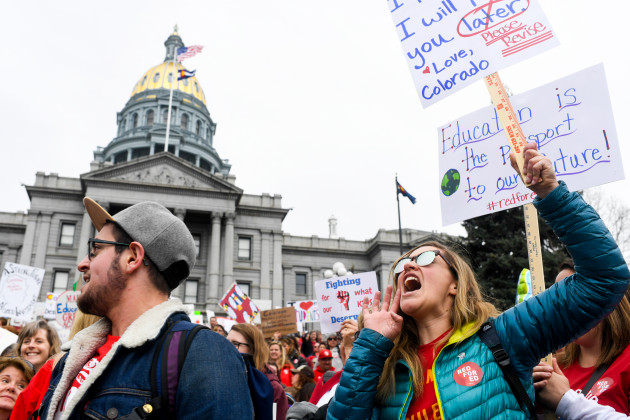 Teachers march during a rally for more educational funding at the Colorado State Capitol in April 2018.