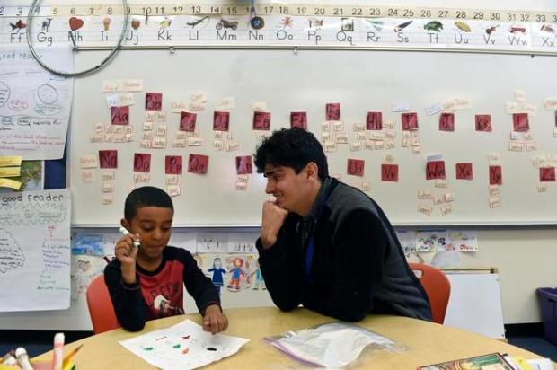 Substitute teacher Steven Mares, right, works with a student at Denver Green School in 2016. (Photo by Helen H. Richardson/The Denver Post)