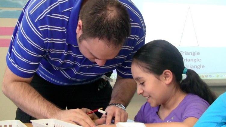 A teacher works with a student at Center's Haskin Elementary.