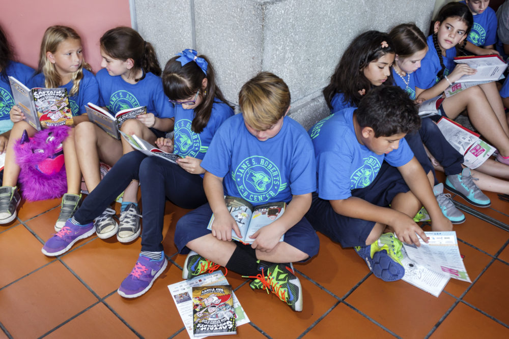 Students reading at the Book Fair International at Miami Dade College Wolfson Campus. (Photo by: Jeffrey Greenberg/UIG via Getty Images)