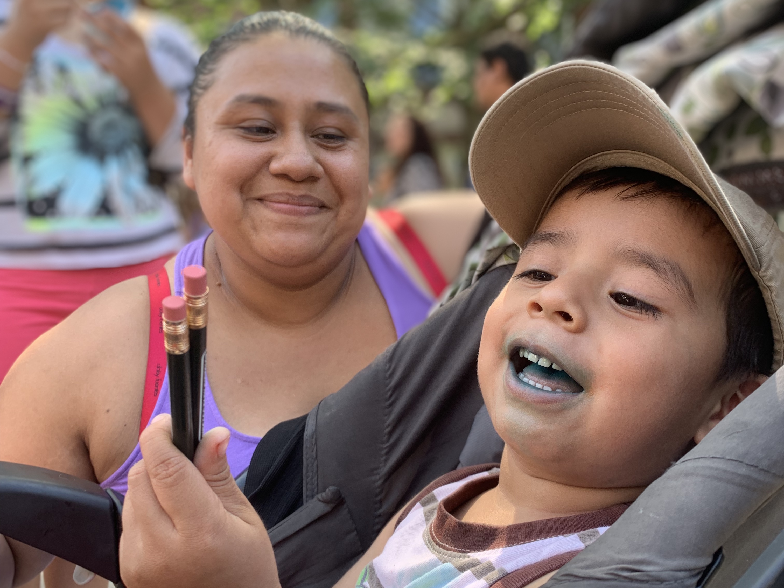 Maria Garcia and her son Leonardo wait in line for free school supplies at the first back to school bash.