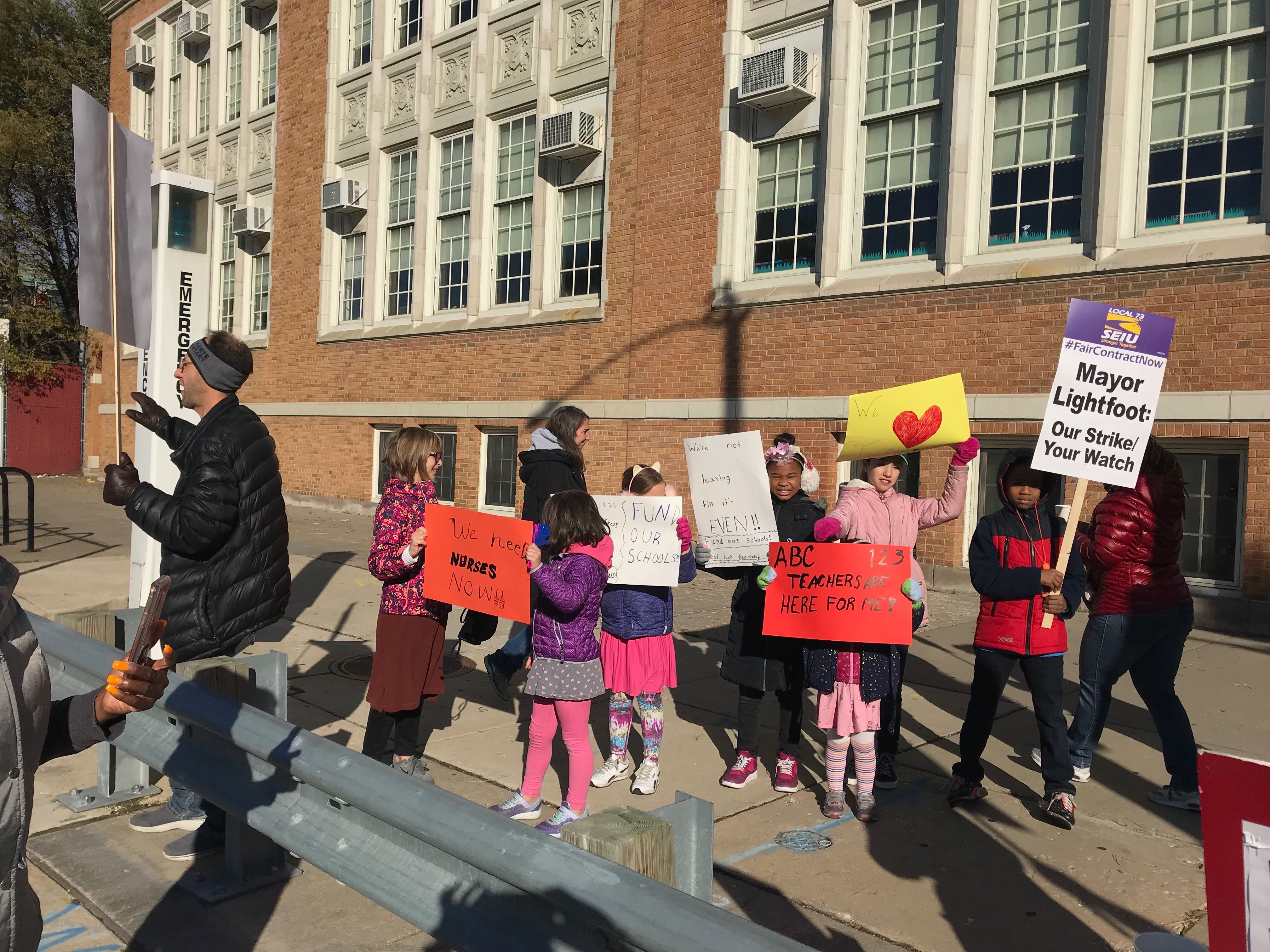 John Hieronymus and his two children joined the picket line at Bret Harte Elementary in Hyde Park on Oct. 17, 2019.