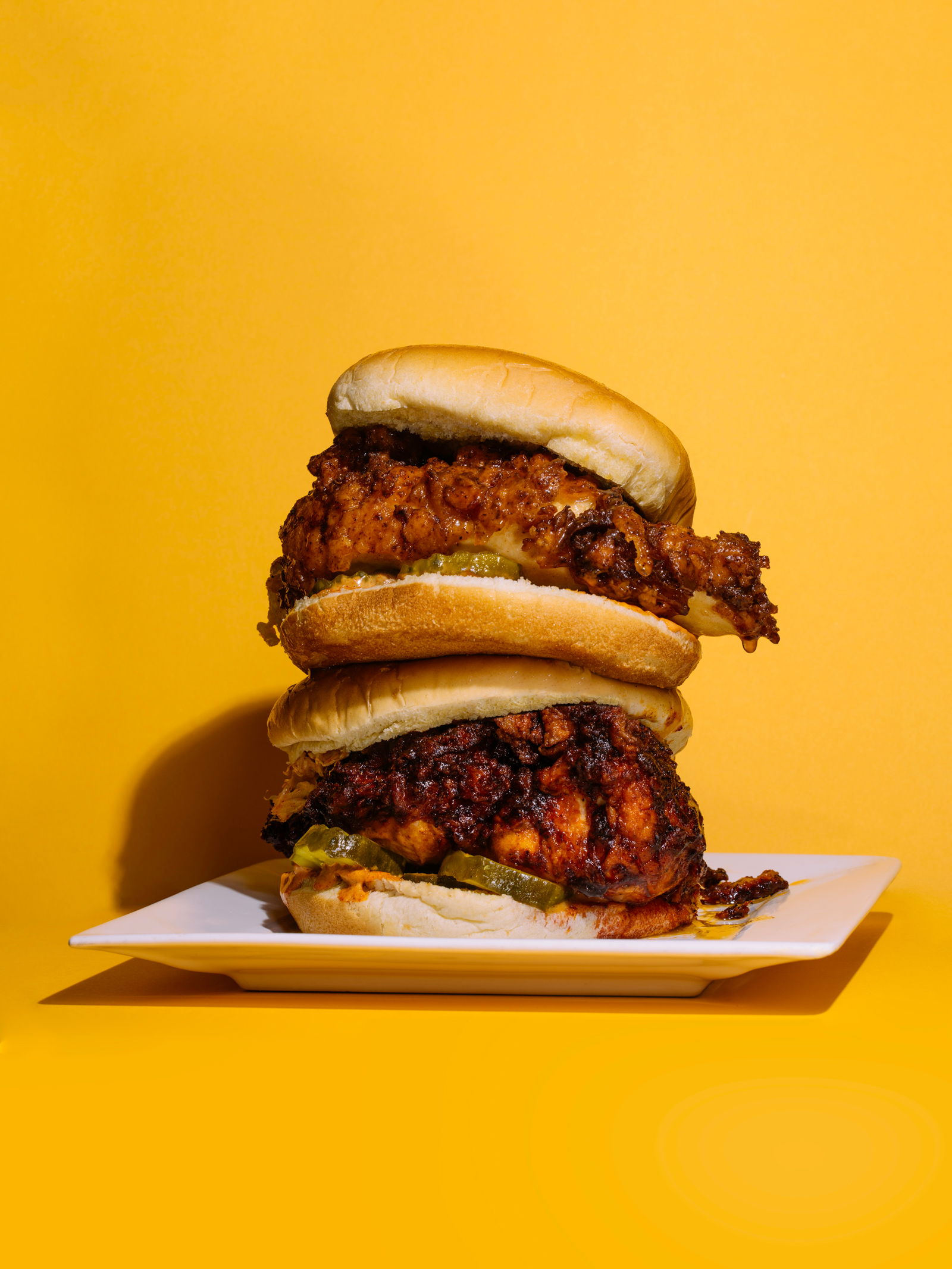 Stack of fried chicken sandwiches from Kowbird