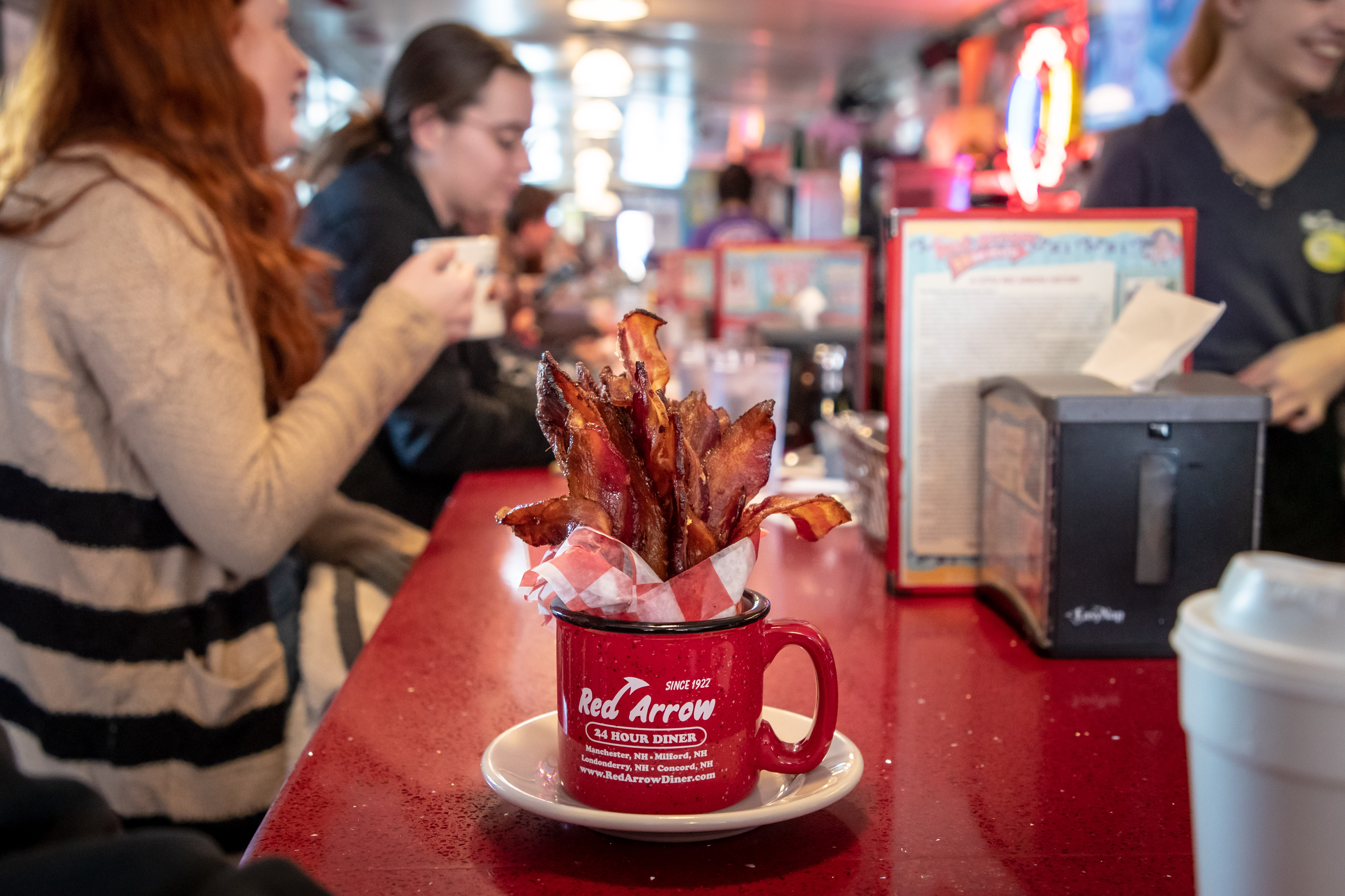 A mug with bacon strips