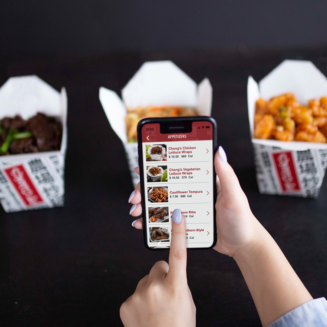 A person ordering Chinese food using the P.F. Chang’s app