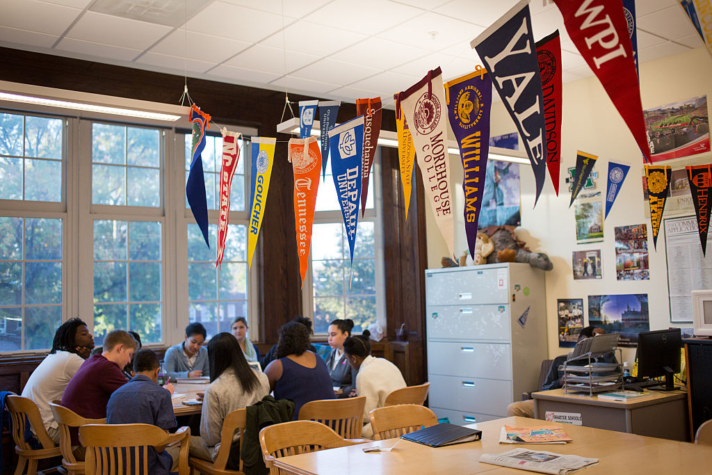 College banners hang in the classroom of teacher Chrys Latham, as she leads a senior advisory period, at Washington Latin Public Charter School.