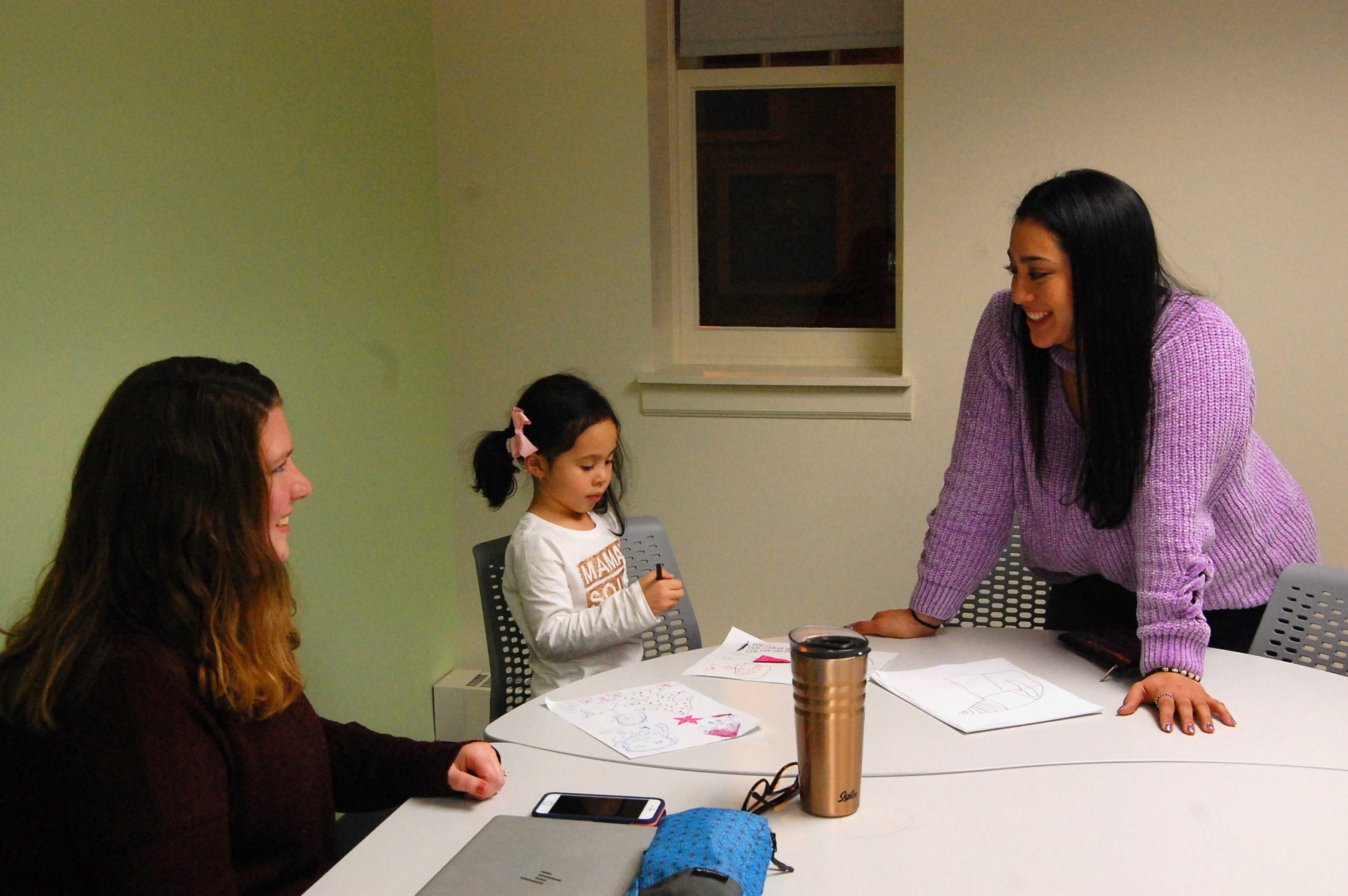 In December, Afrodita Salgado (right) brought her 5-year-old daughter, Amelia, to meet with her coach, Angela Crawford Neven, in a Chicago public library as part of a new online college program.