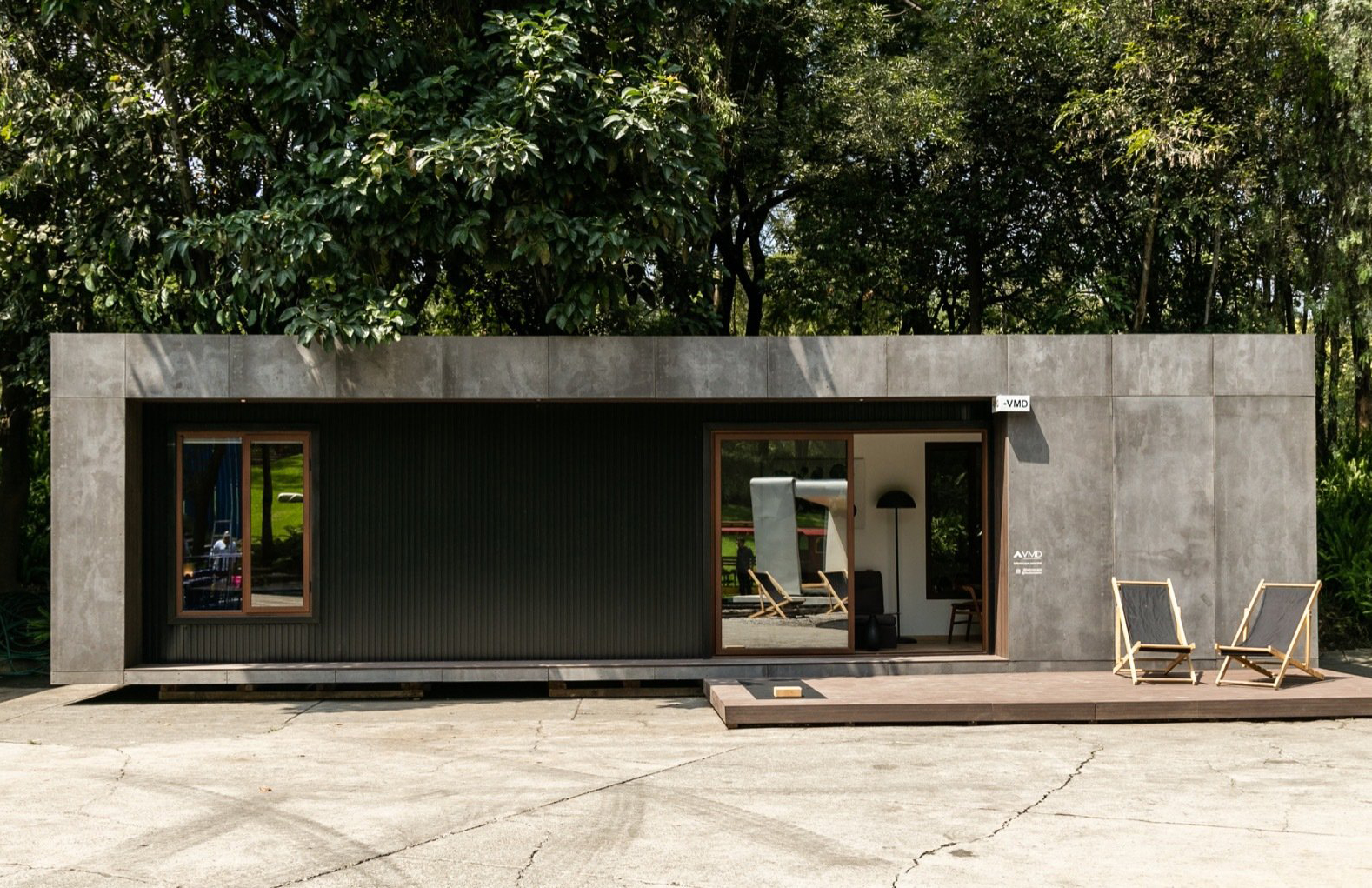 House clad in concrete and metal panels.