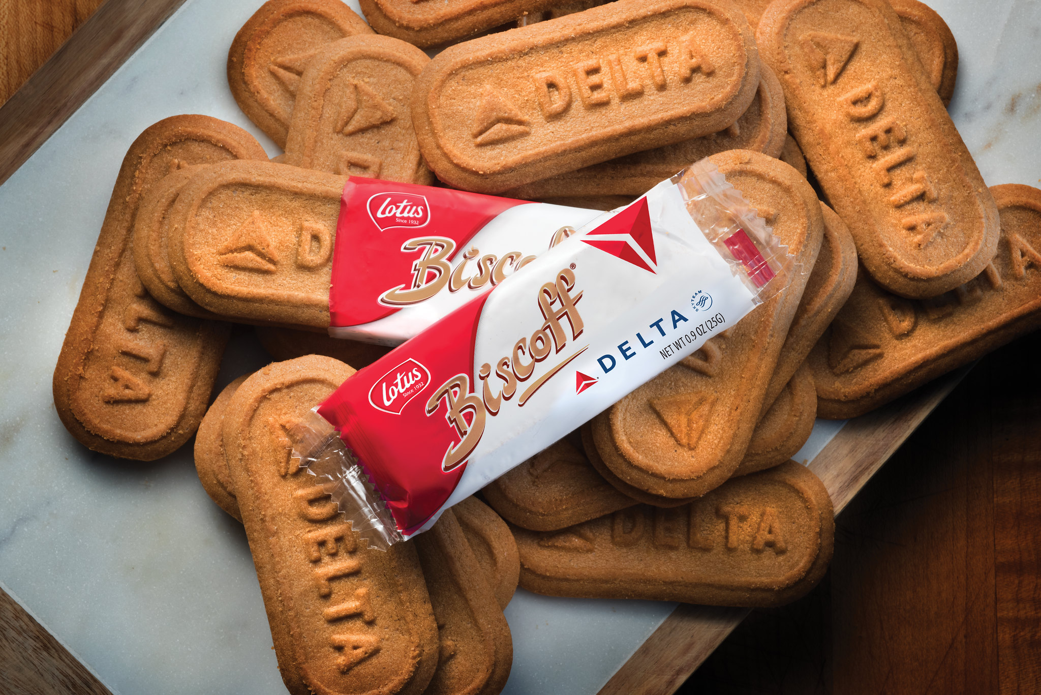 A pile of Delta-branded Biscoff cookies sit on a tray table