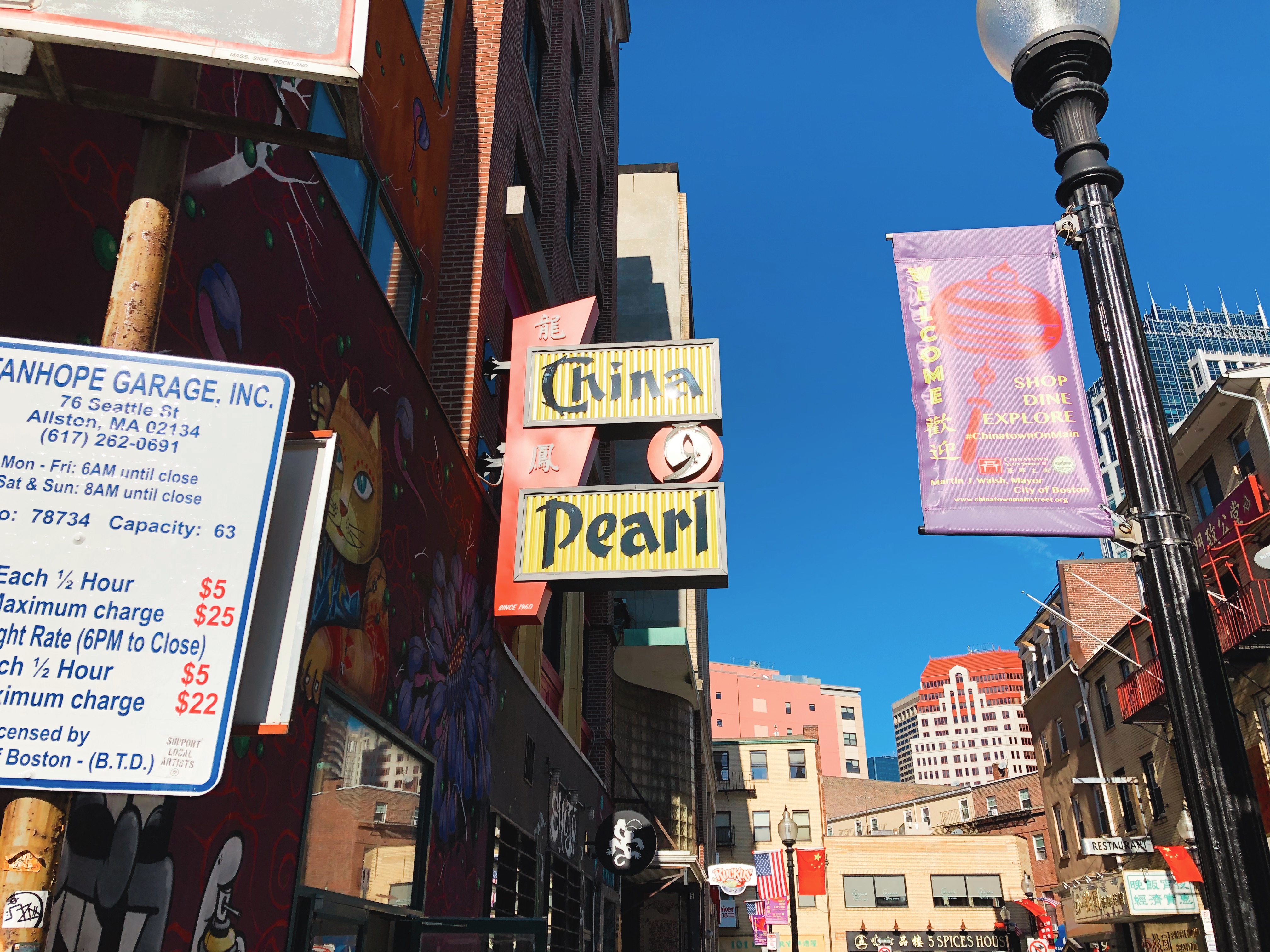 The sign at China Pearl in Boston’s Chinatown. It is yellow with red accents and black font.