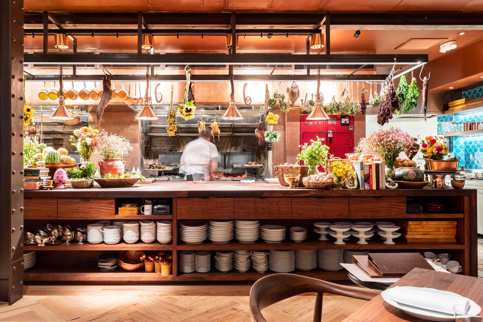 The live fire kitchen at Angler with hanging flowers