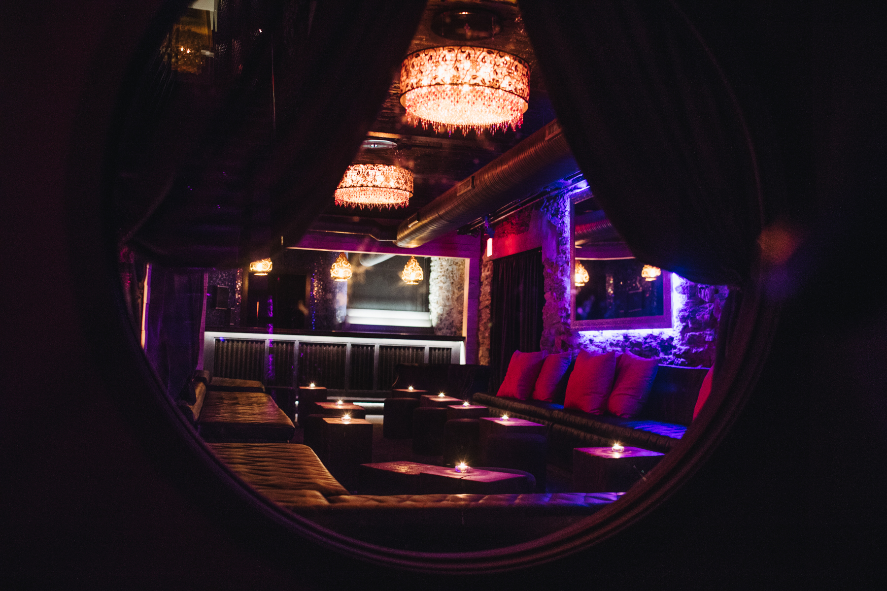 dark lounge with chandeliers and candles