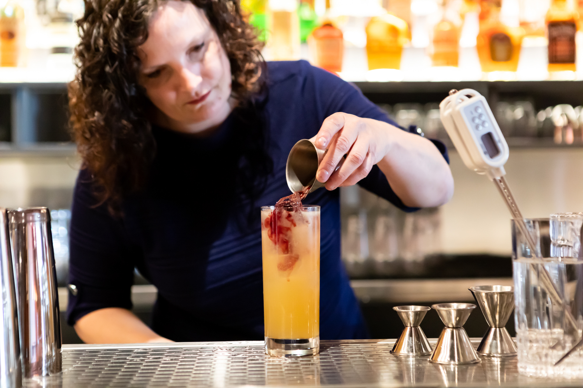 Owner Jennifer Colliau mixes a drink at Here’s How