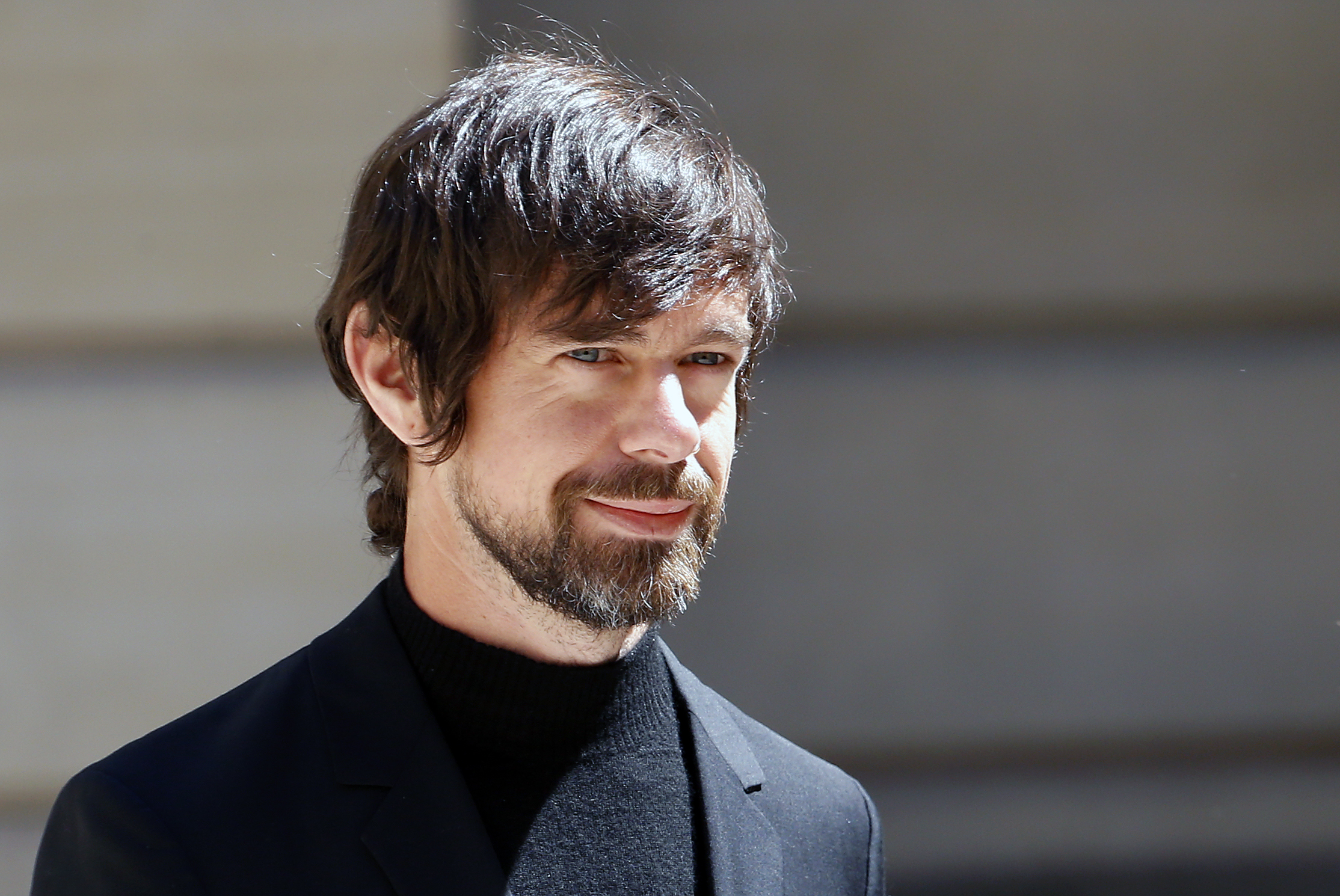 Jack Dorsey stands in the sunshine at the “Tech For Good Summit” at Hotel De Marigny in Paris.