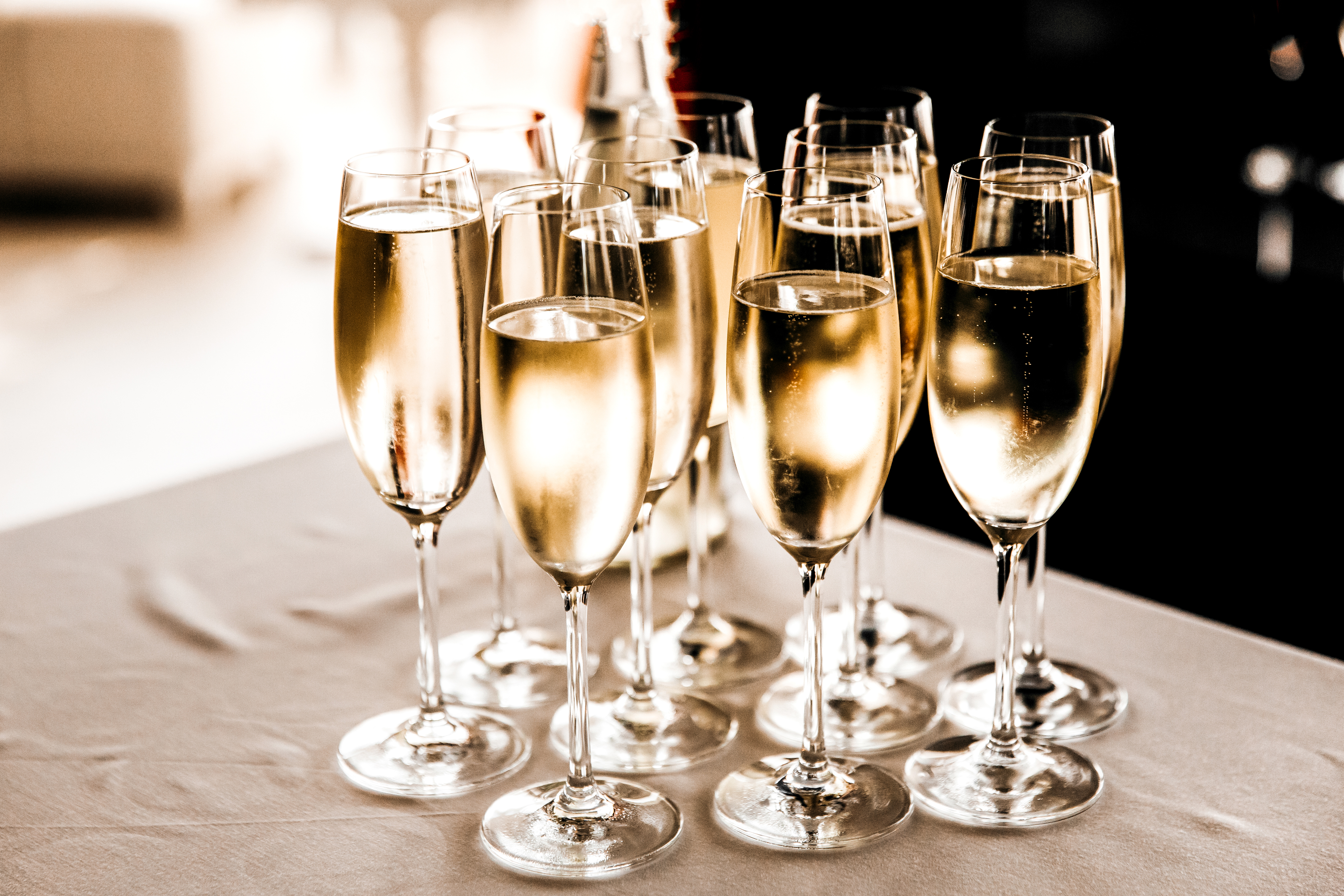Champagne flutes filled with Champagne on a table