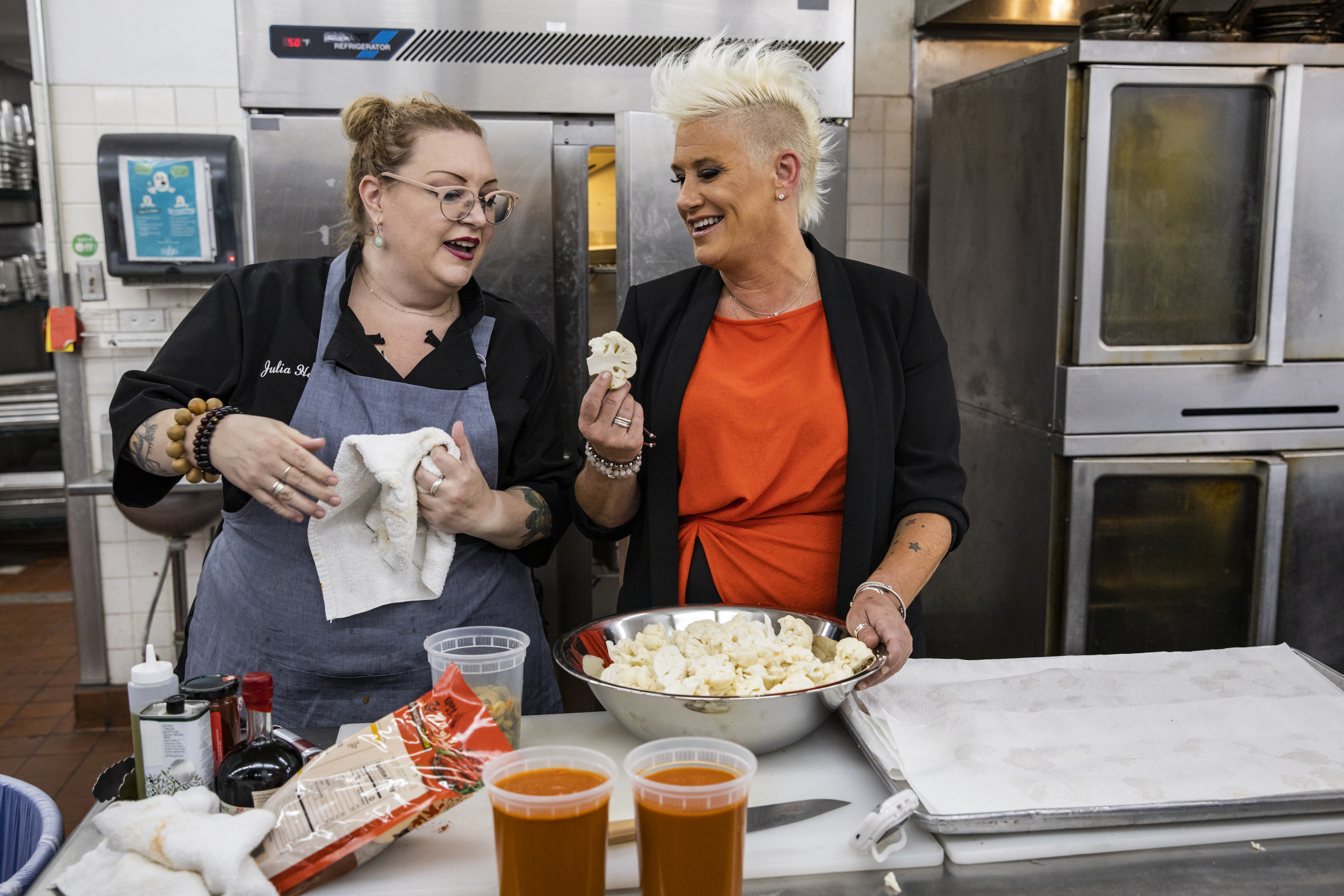 Competitor Julia Helton with host Anne Burrell, as seen on Vegas Chef Prizefight, Season 1.
