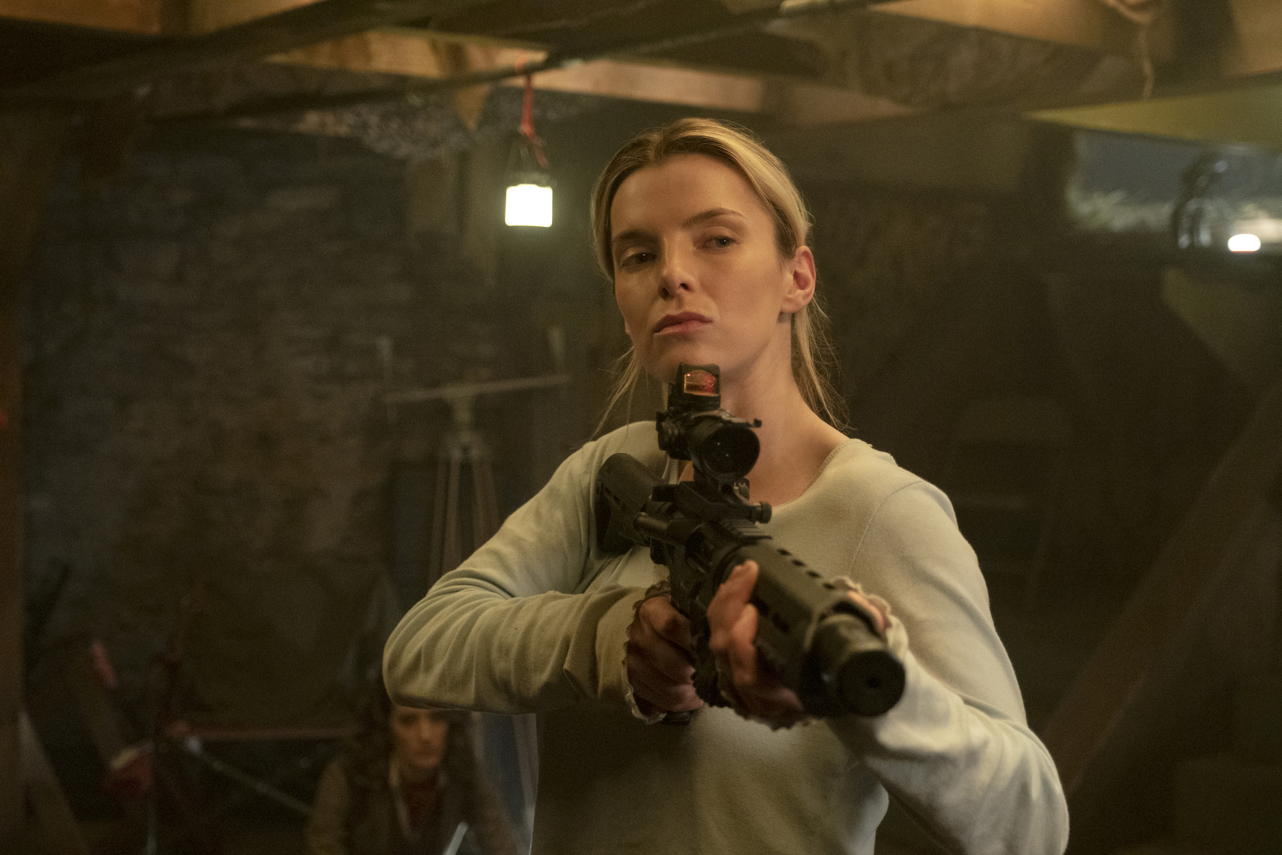 Crystal (Betty Gilpin) holds a rifle in The Hunt